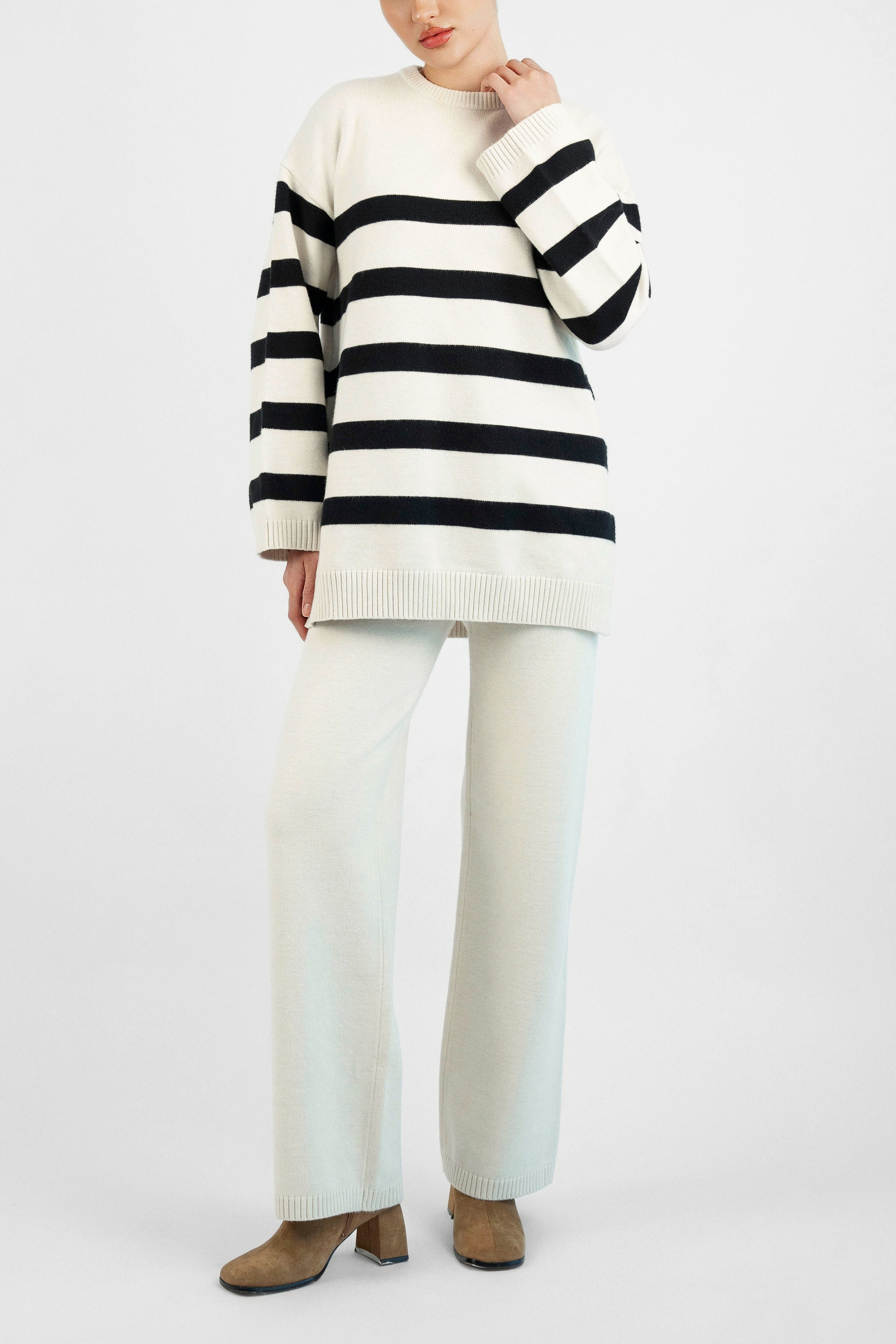 Style: Stripped. A closer look of a girl in a front pose wearing a Cloud Knit Sweater