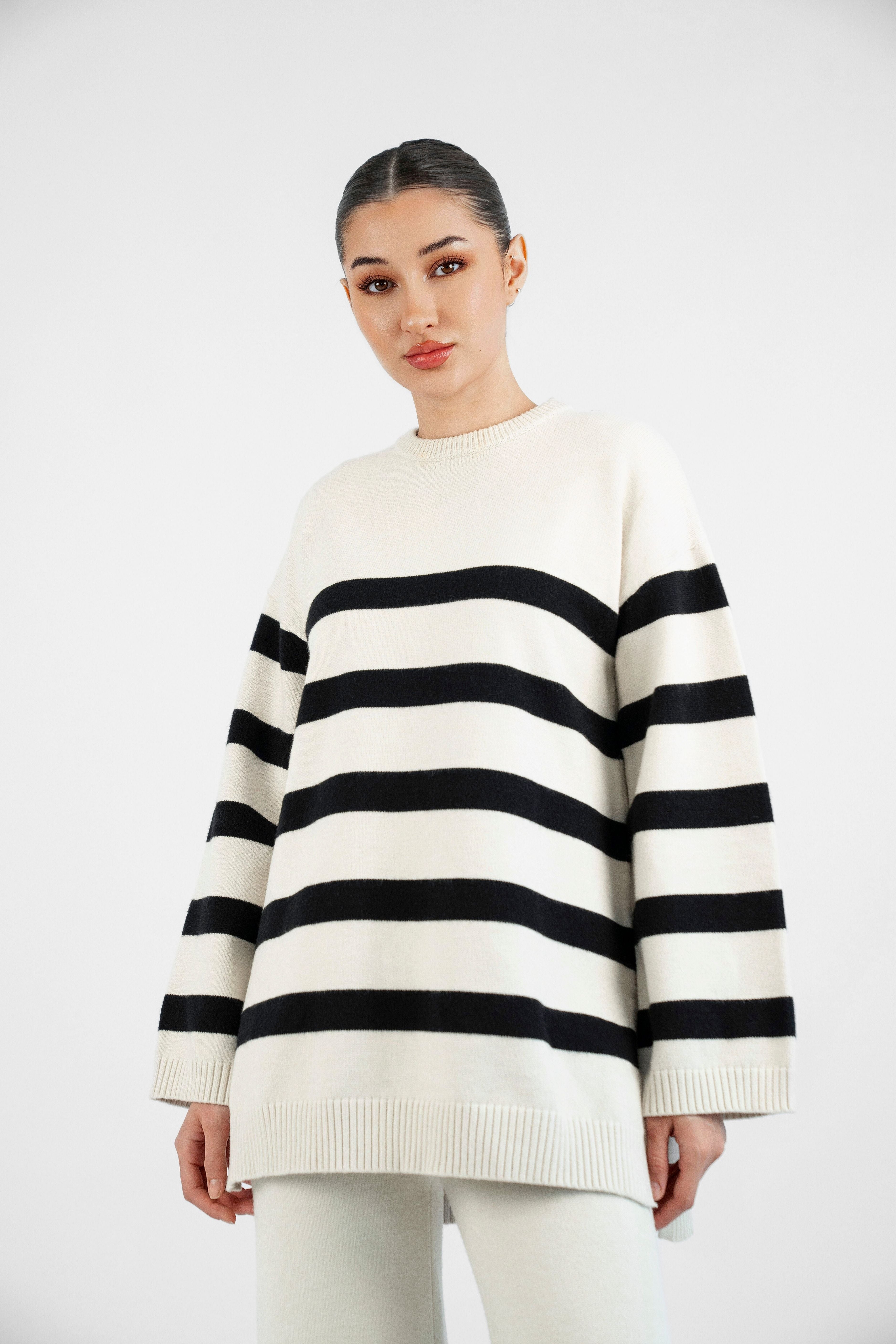 Style: Stripped. A close look of a model facing the camera in a Cloud Knit Sweater