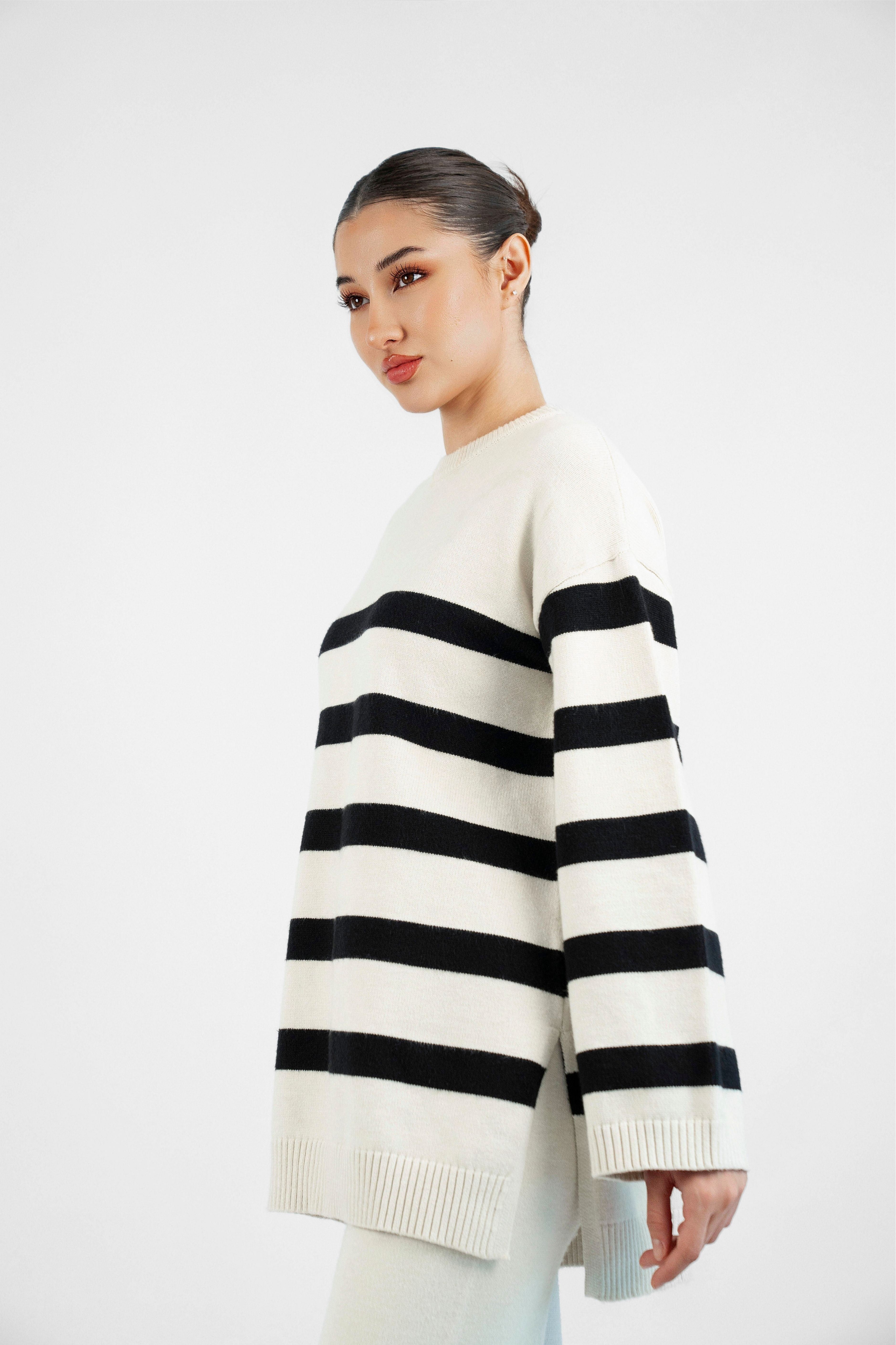 Style: Stripped. A side pose of a girl in a Cloud Knit Sweater