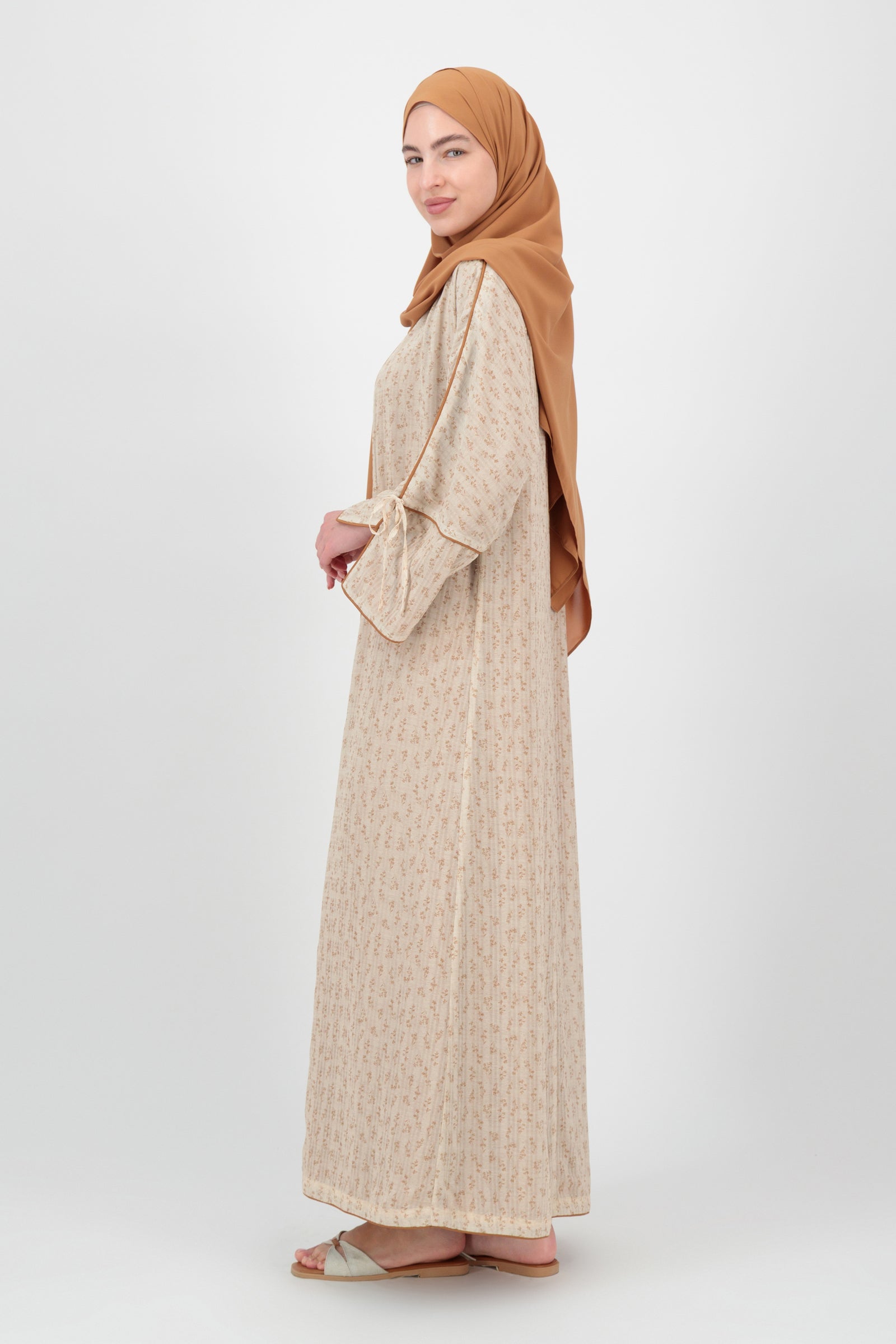 Side profile of the FARES Printed 3 Piece Abaya Set in Tamr capturing the clean drape and graceful structure designed as a modern abaya for women.