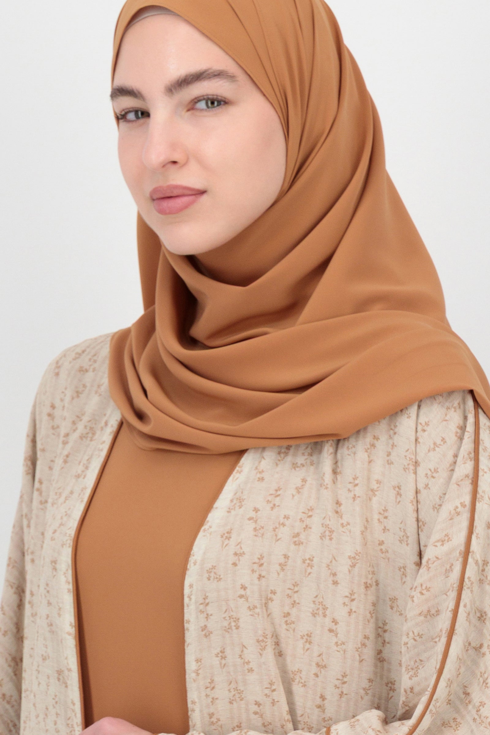 Close-up portrait styling of the FARES Printed 3 Piece Abaya Set in Tamr focusing on the fabric texture and refined finish that define premium abayas.