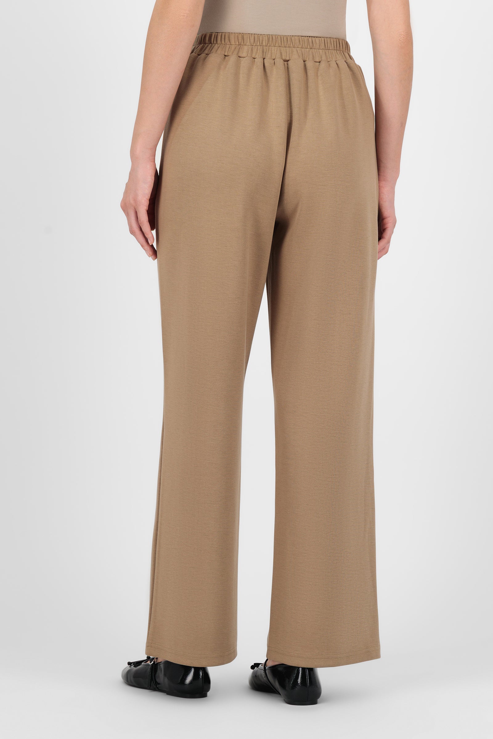 Back view of the Buttery Straight Leg Trousers Toffee highlighting the streamlined waistband and relaxed cut that give these trouser pants for women a polished finish.