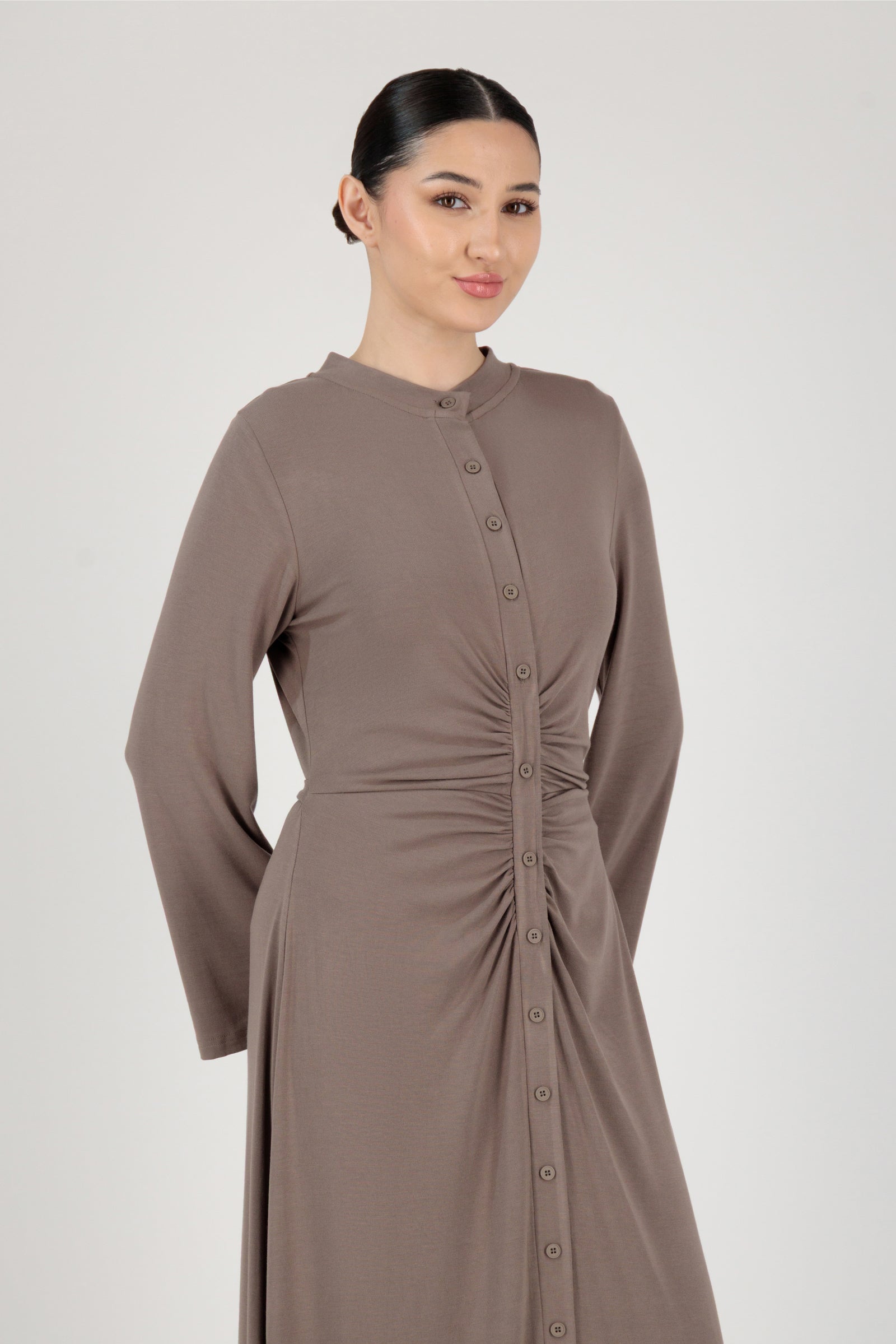 Side angle of the FARES Gathered Waist Knit Dress in Pebble presenting a refined knit dress shape with gentle structure.