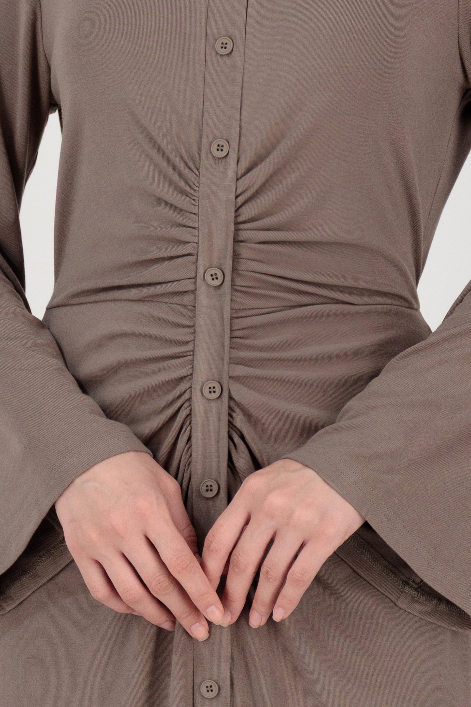 Close-up detail of the FARES Gathered Waist Knit Dress in Pebble focusing on the gathered waist and knit texture of this knit dress.