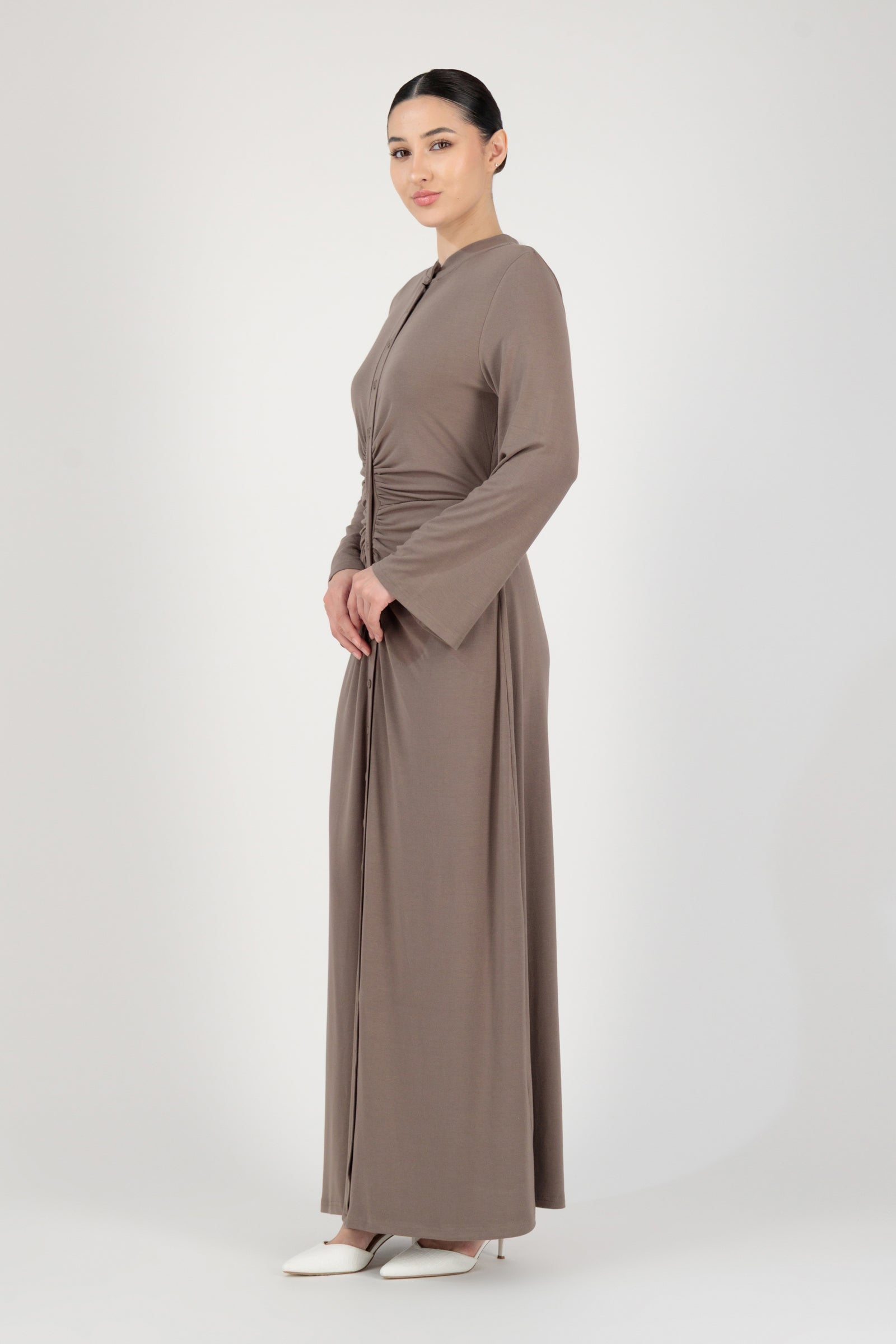 Side profile of the FARES Gathered Waist Knit Dress in Pebble highlighting the flow and length of this long sleeve dress.