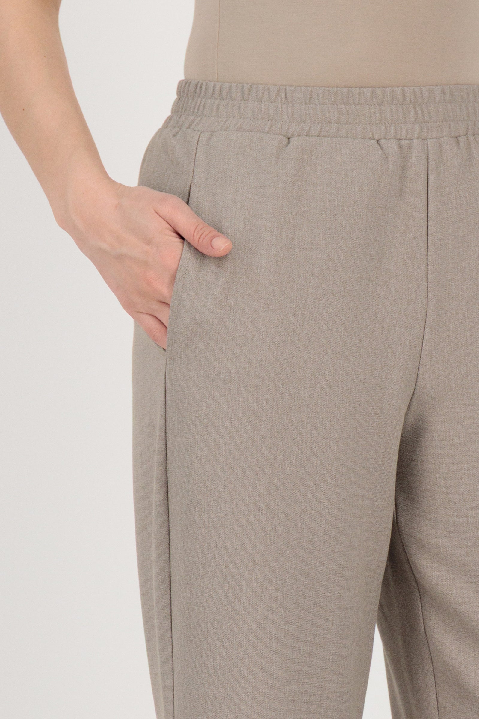 Close-up detail of the FARES Tailored Elastic Waist Pants in Stone focusing on the elastic waistband and pocket construction of these elastic waist pants.