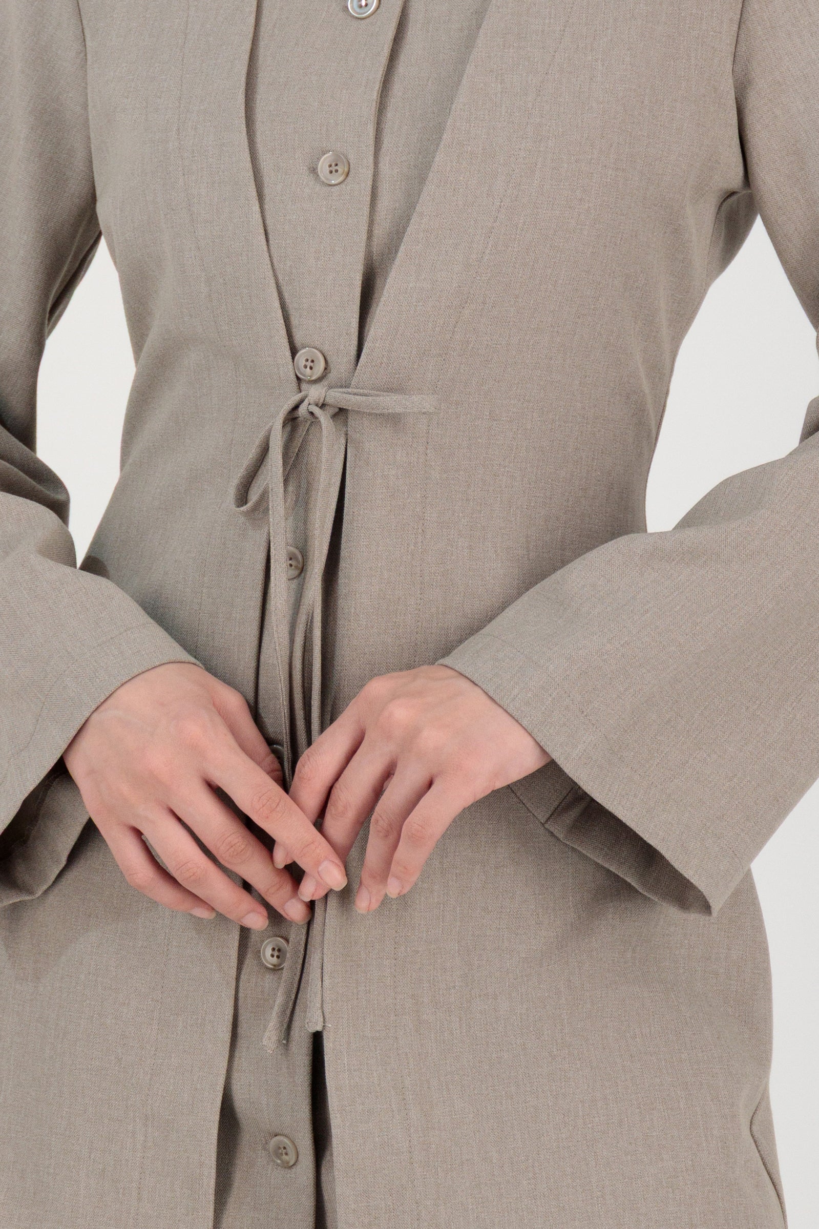 Close-up detail of the FARES Tailored Button-Up Tunic in Stone focusing on the button-up front and fabric texture of this tunic.