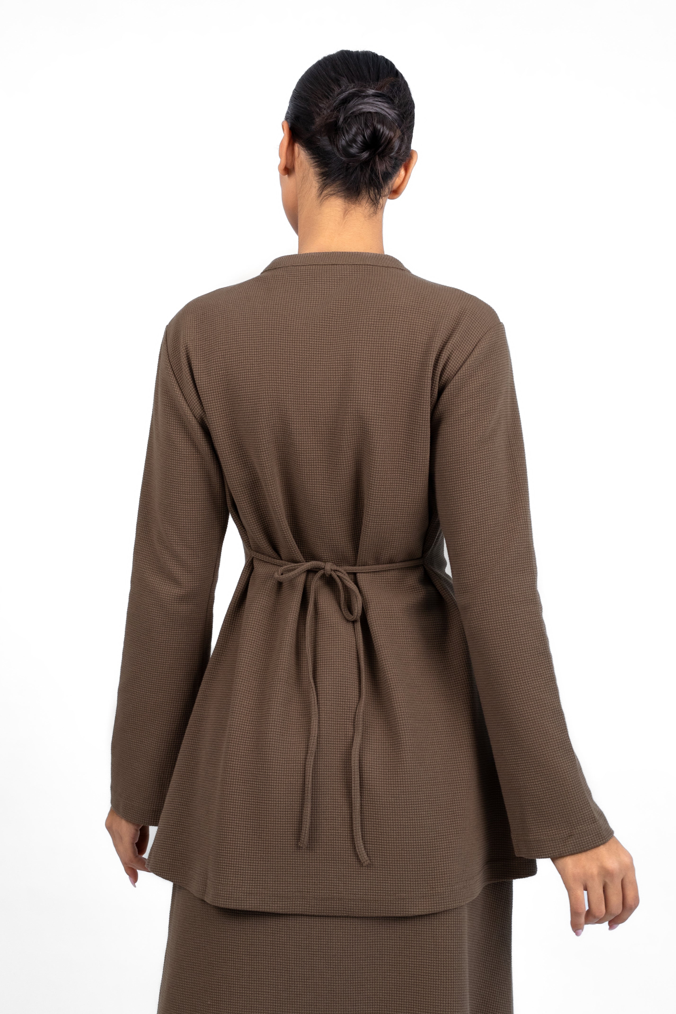 A back pose in a Tailored Vintage Cardigan. Colour: Coffee