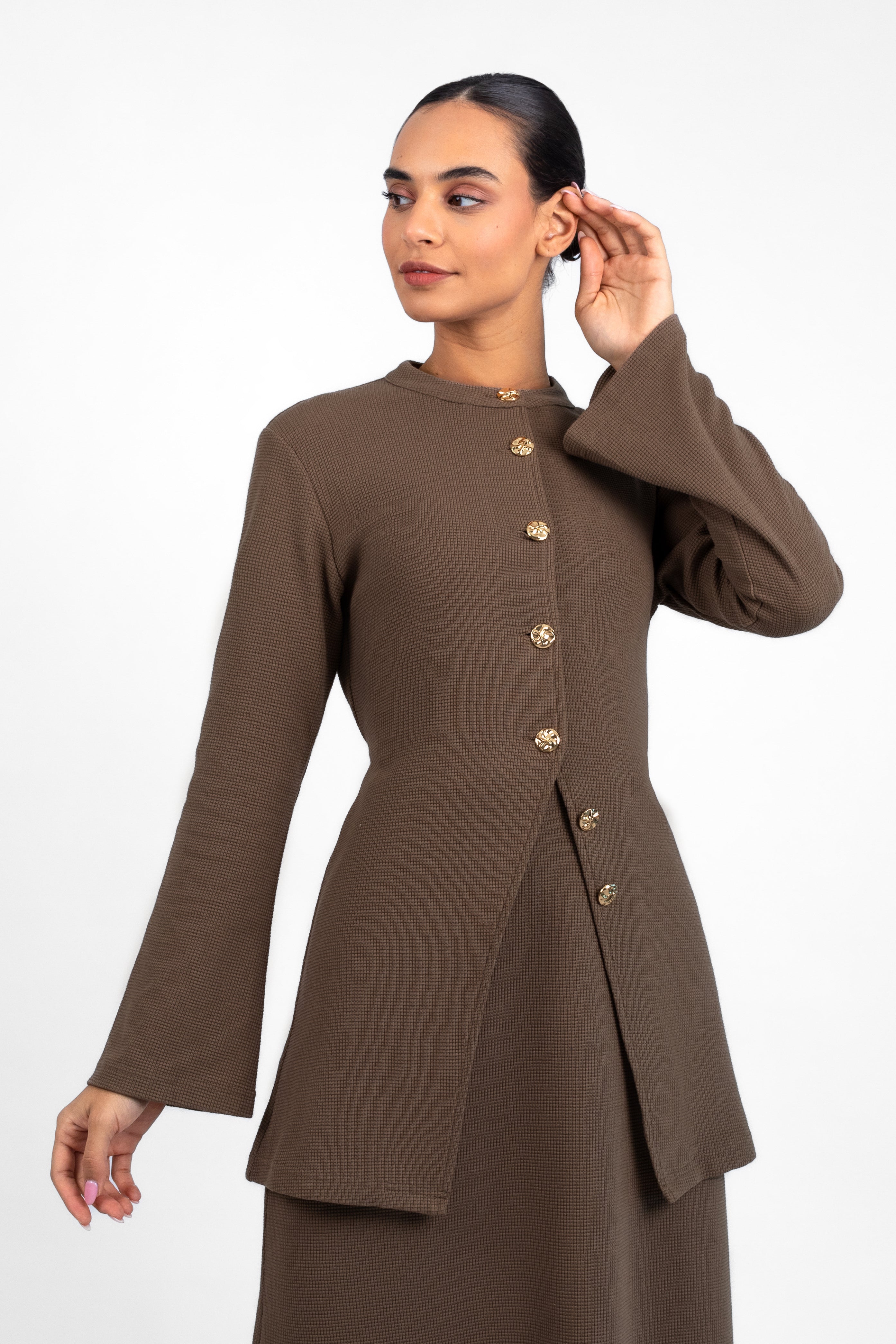 A close up of a model in a front pose in a Tailored Vintage Cardigan. Colour: Coffee