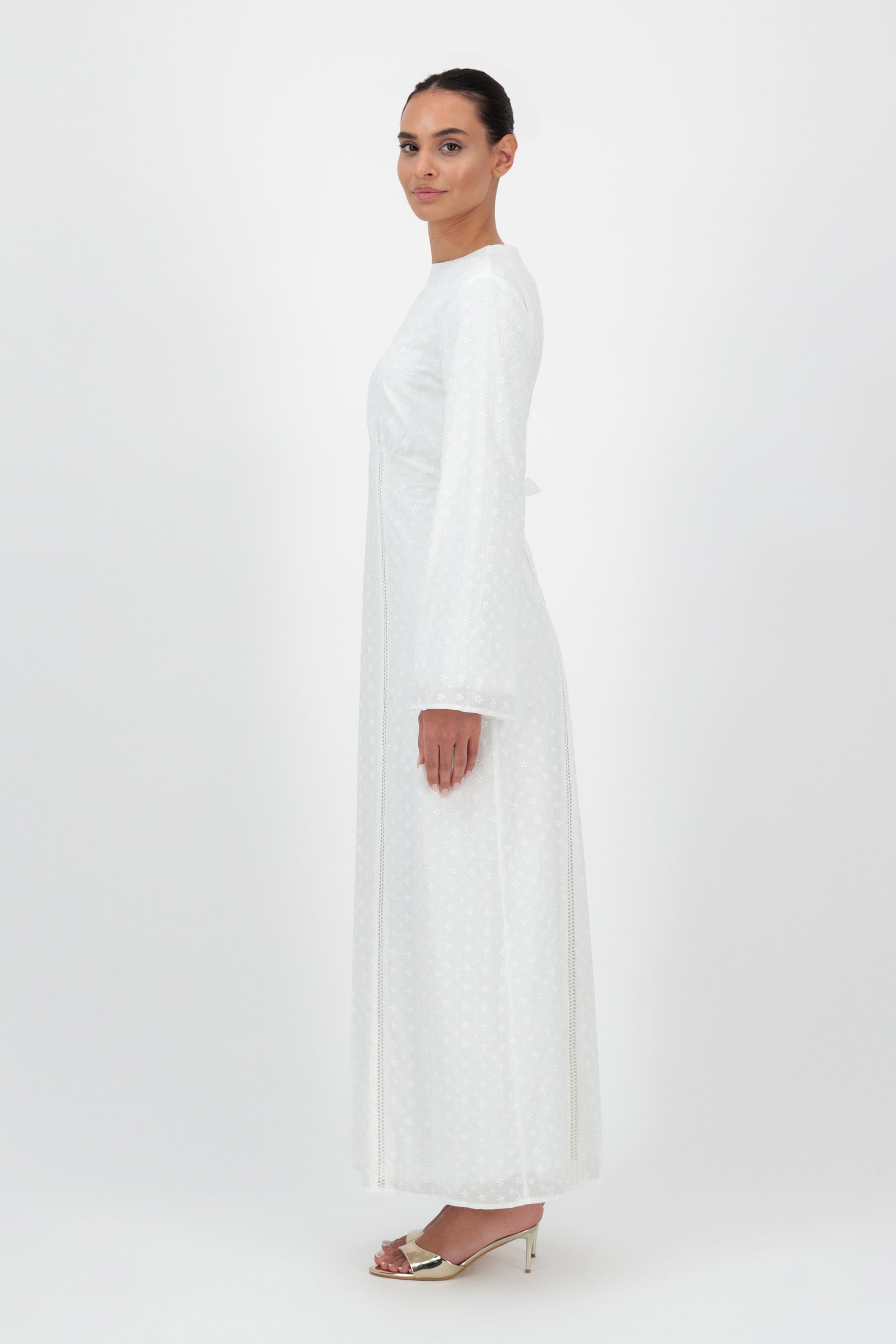 Side view of the FARES Embroidered Floral Dress in White highlights the clean lines and flowing structure of this timeless floral dress for women.