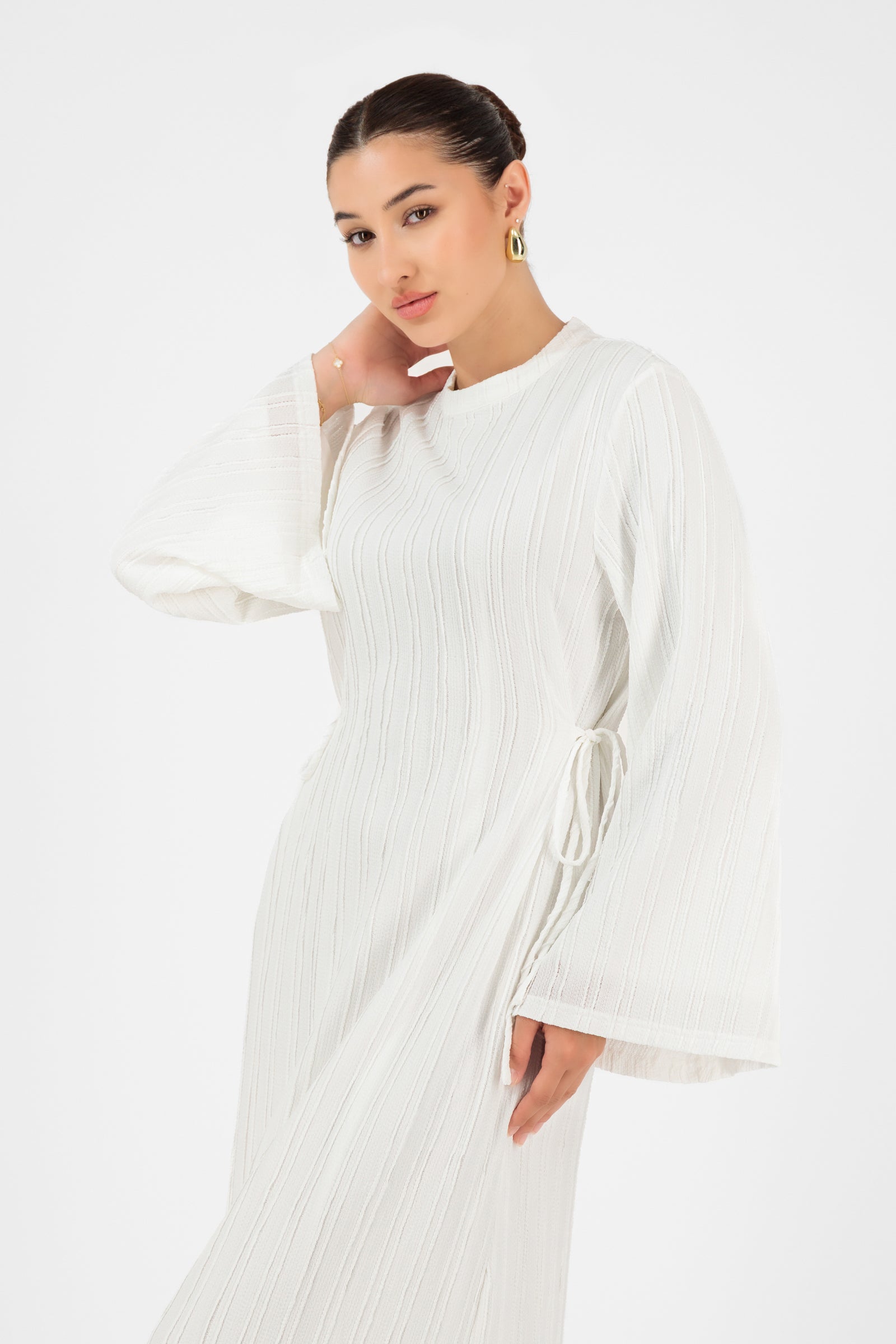 Close-up of the FARES Textured Bow Detail Dress in White highlighting the textured fabric and feminine bow details on this maxi dress.