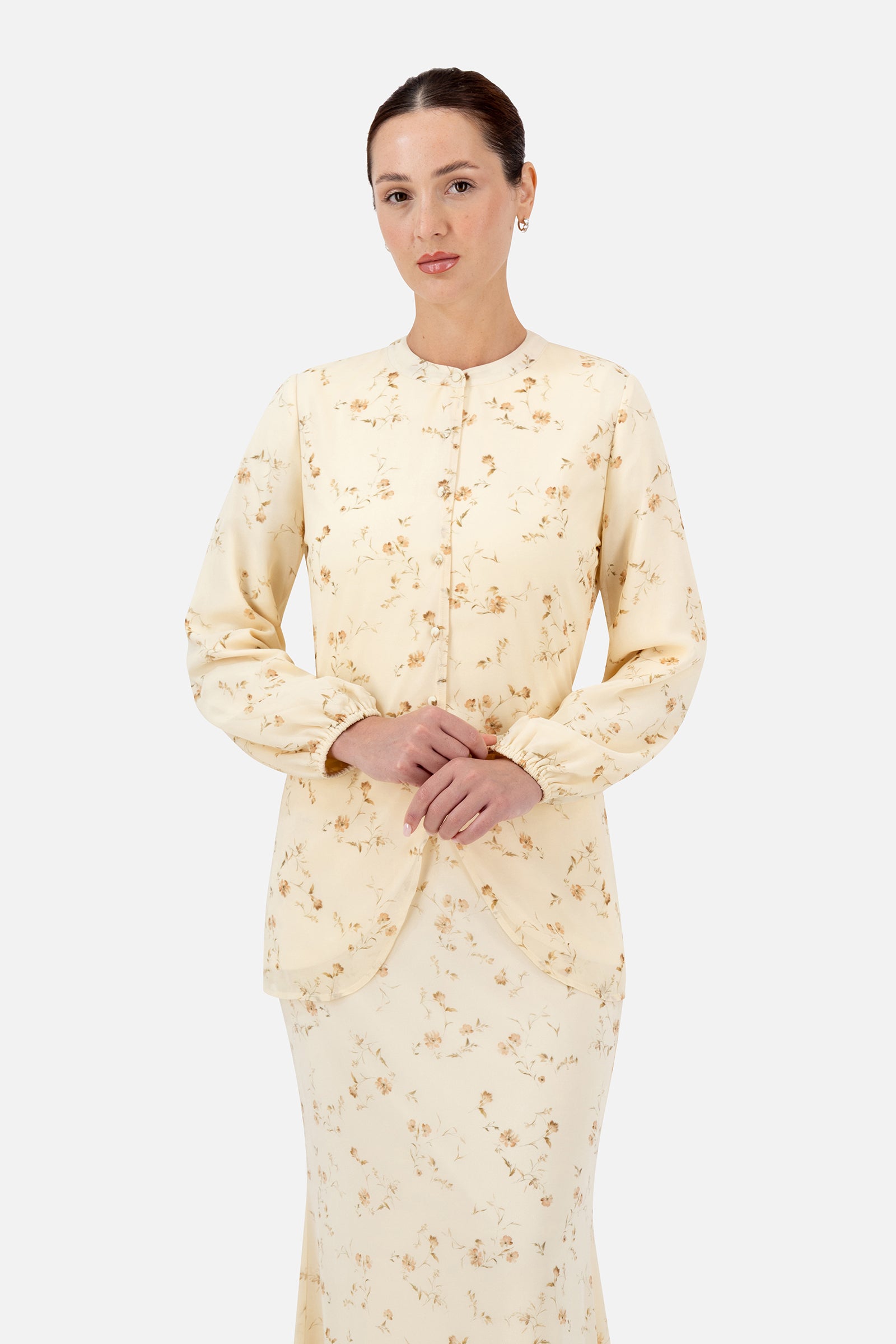Woman wearing the Butterbloom curved split hem blouse, front view with a flattering tailored silhouette.