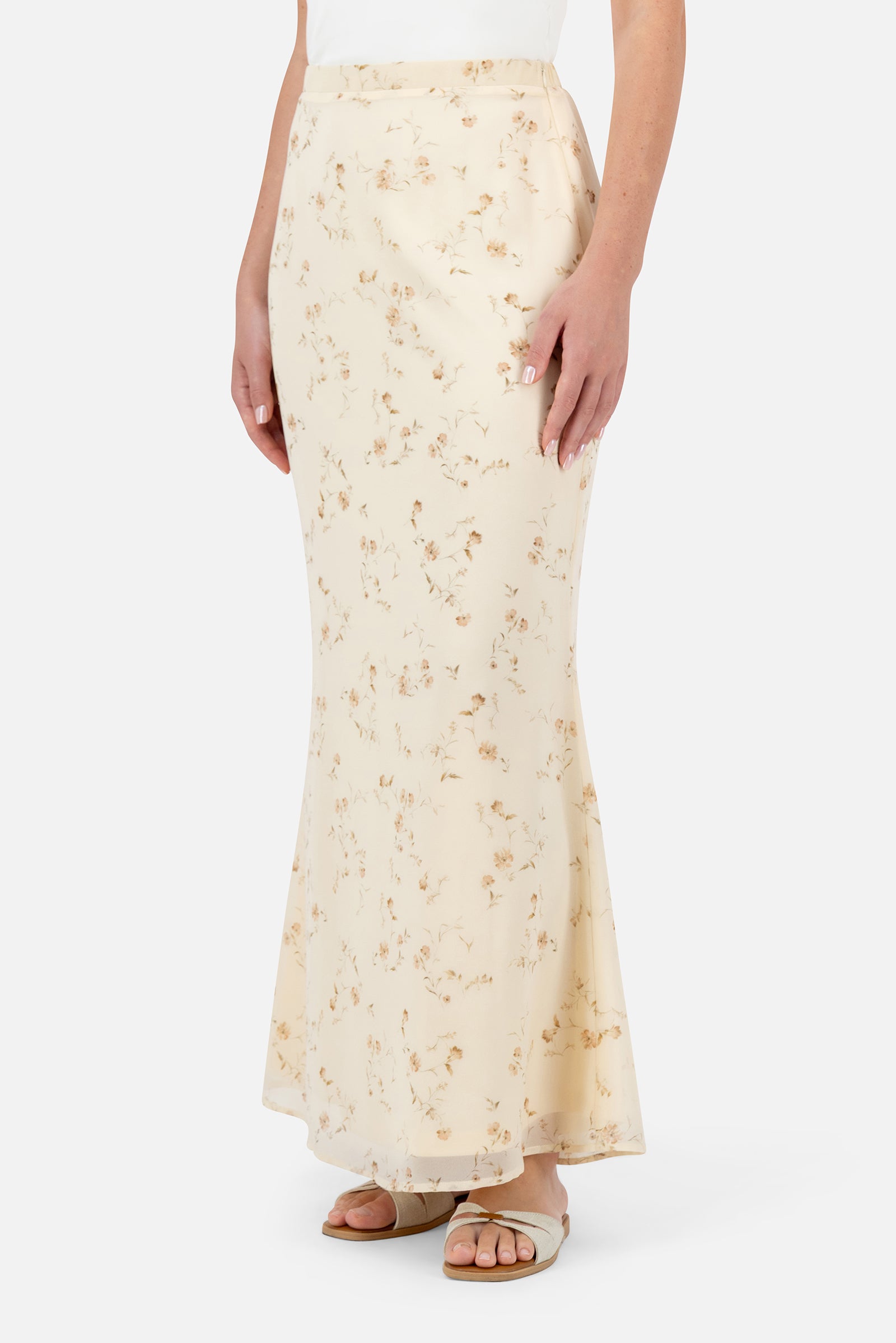 Woman standing in the Butterbloom maxi skirt paired with the matching curved split hem blouse.