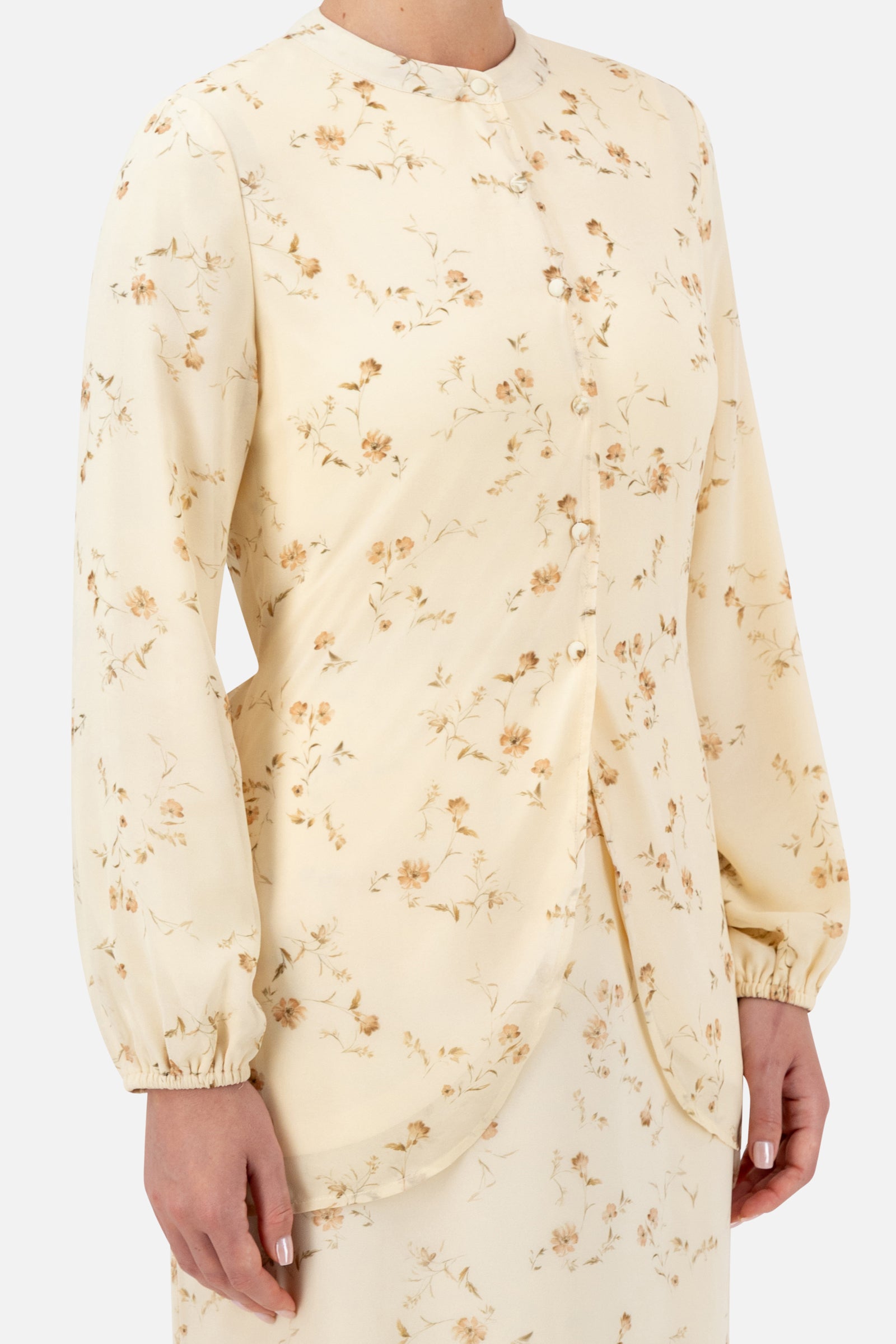 Close-up of the neckline and floral print on the Butterbloom blouse.