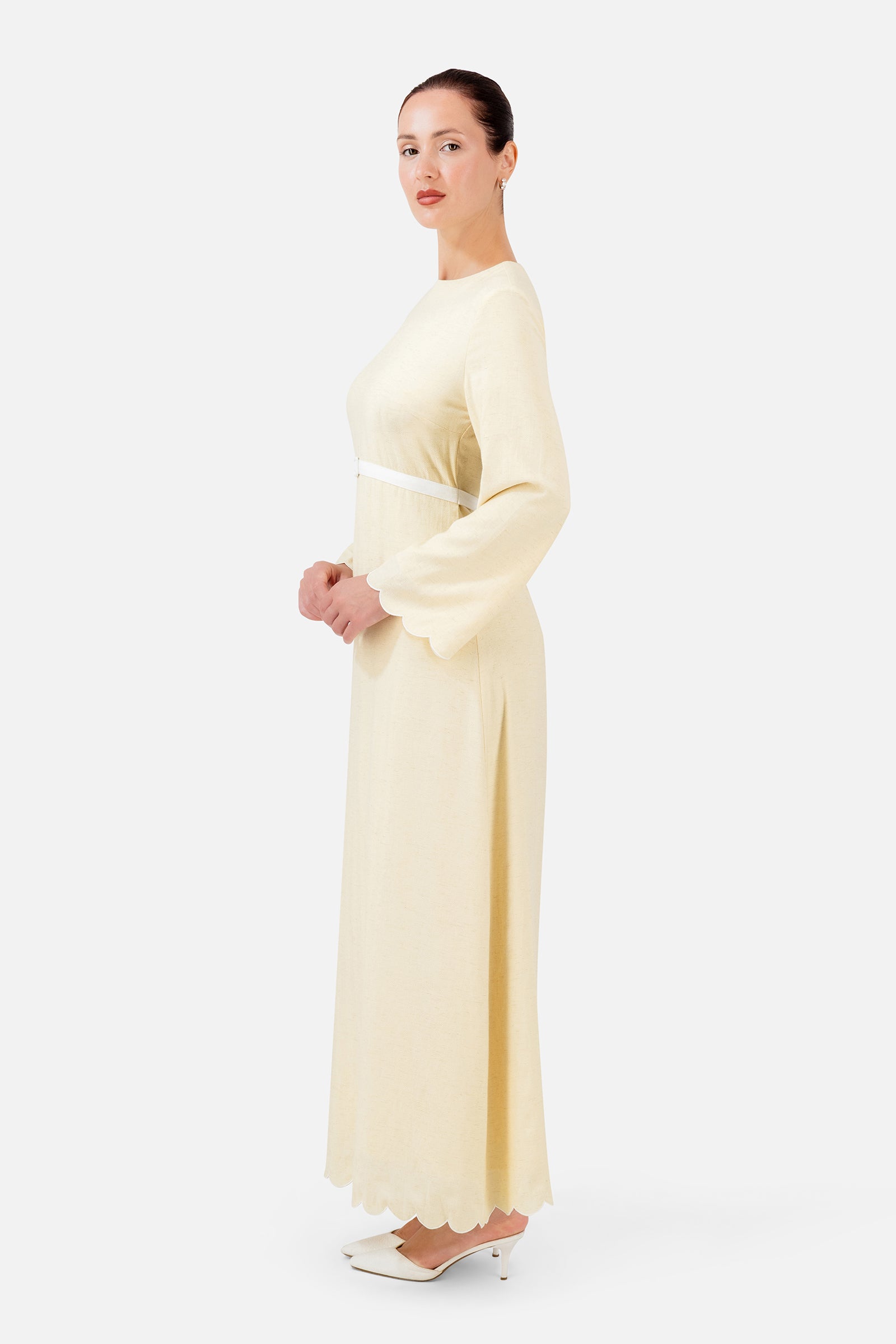 FARES Belt Detail Scalloped Dress in Buttercup shown from the side, featuring a softly flowing shape and delicate scalloped detailing.