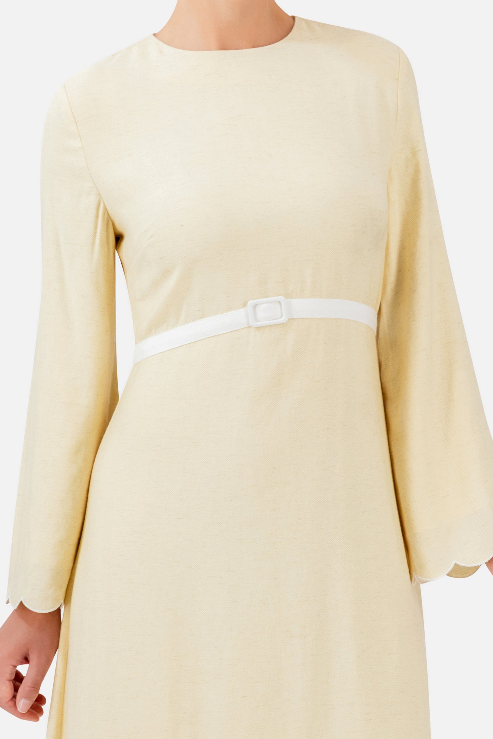 Detailed view of the FARES Belt Detail Scalloped Dress in Buttercup, showing the delicate scalloped finish and belt detail of this dress for women.