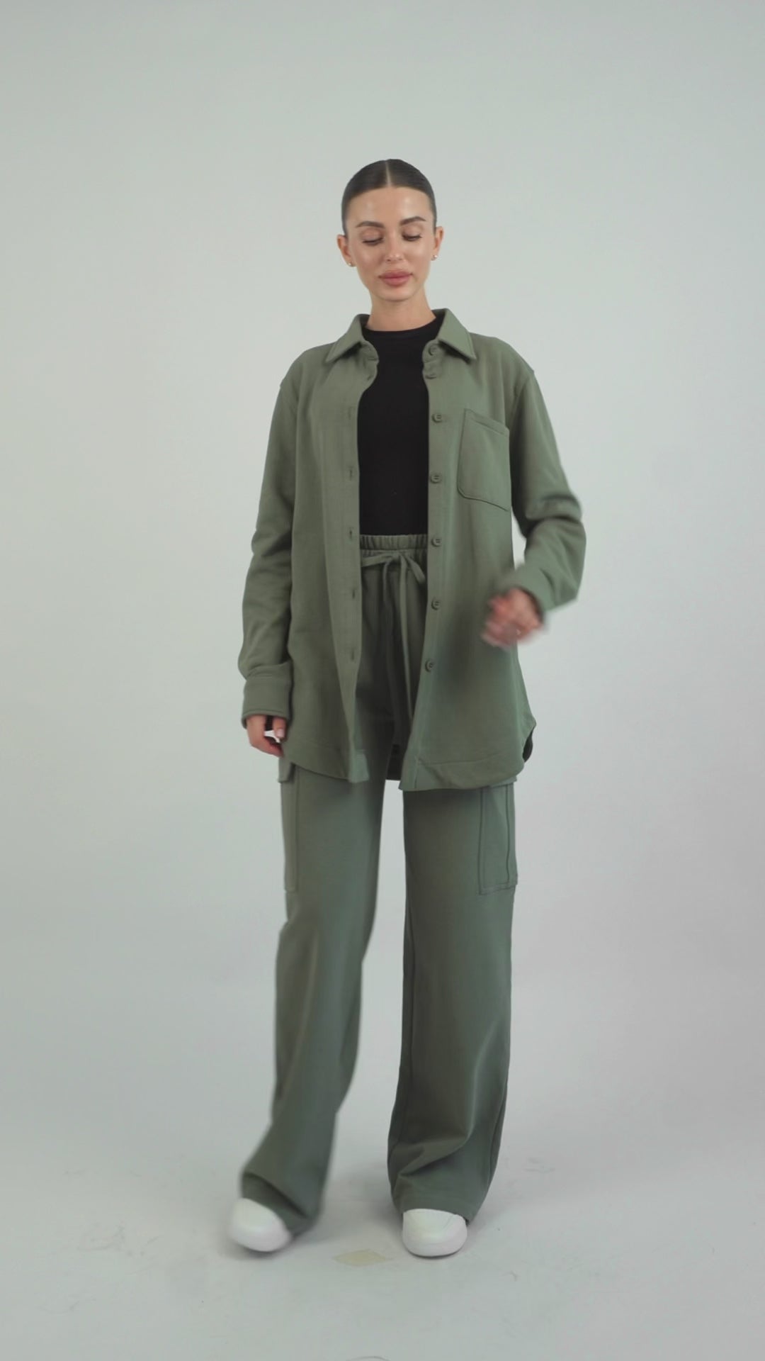 Colour: Oakmoss. A model is showing poses in an Oversized Cotton Shacket.