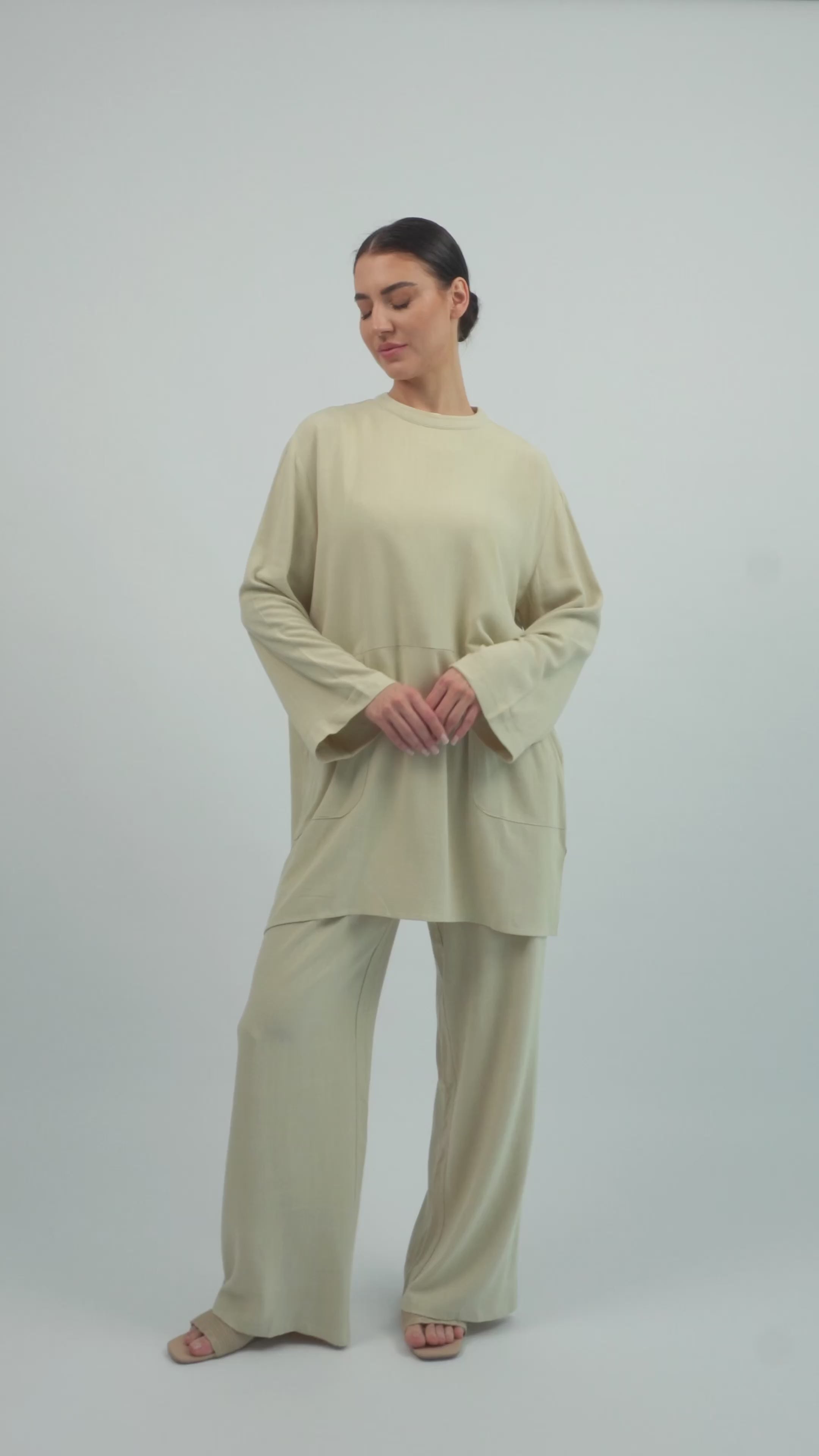 Model walking in the FARES Linen Blend Top in Taupe, showing the fit, movement, and flow of the lightweight linen top.