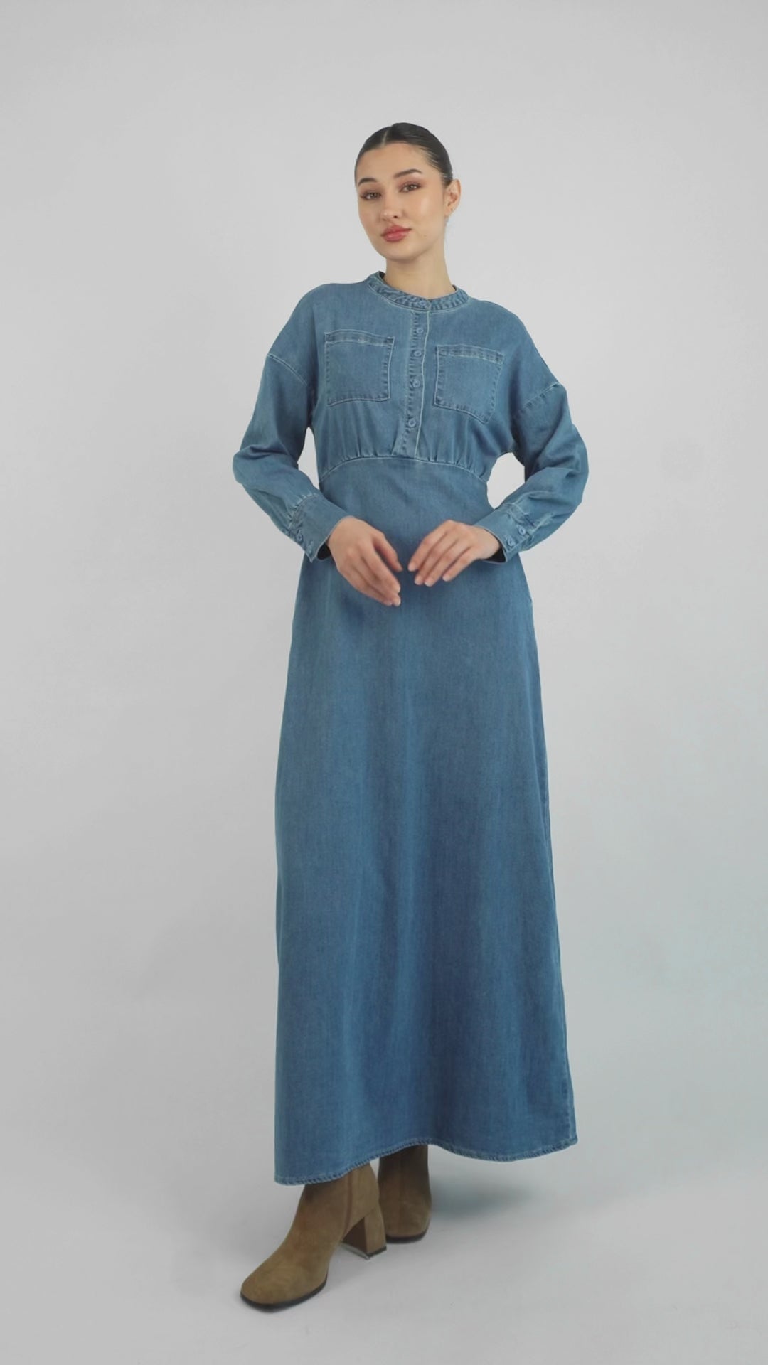 In the video the model is showing a couple of poses showcasing FARES' denim dress. Colour description: Blue.