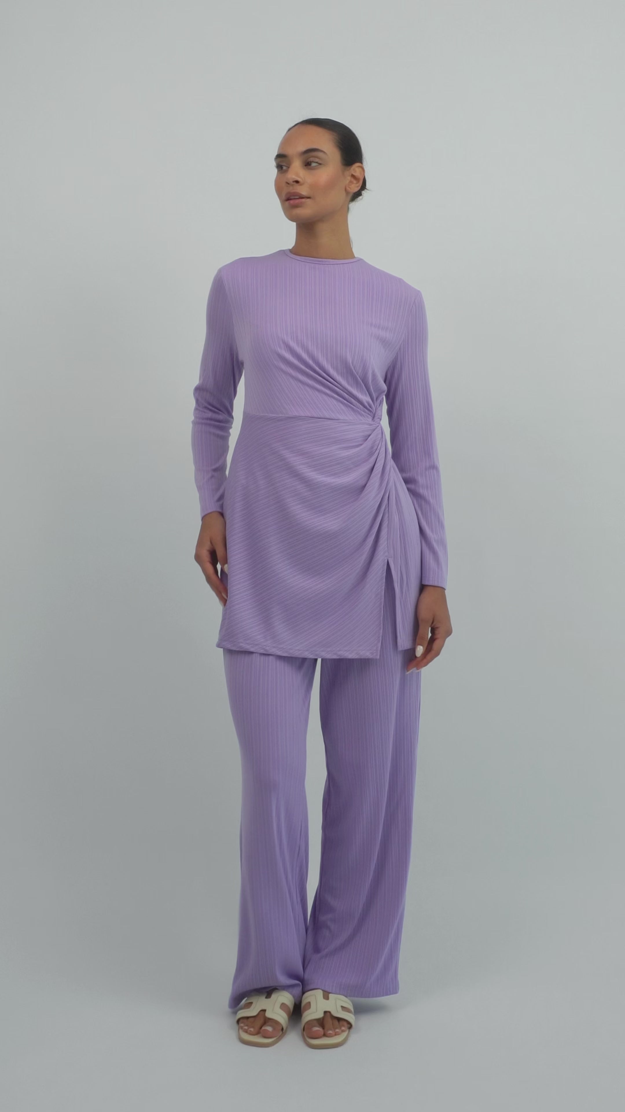 Model walking in the FARES Ribbed Relaxed Fit Pants in Purple, showing the flow and movement of the relaxed fit pants in motion.