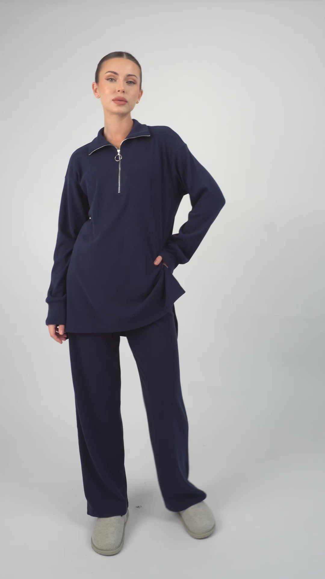 Colour description: Navy Blue. In the video the model is showing a couple of poses showcasing FARES' velour knit half zip sweater.
