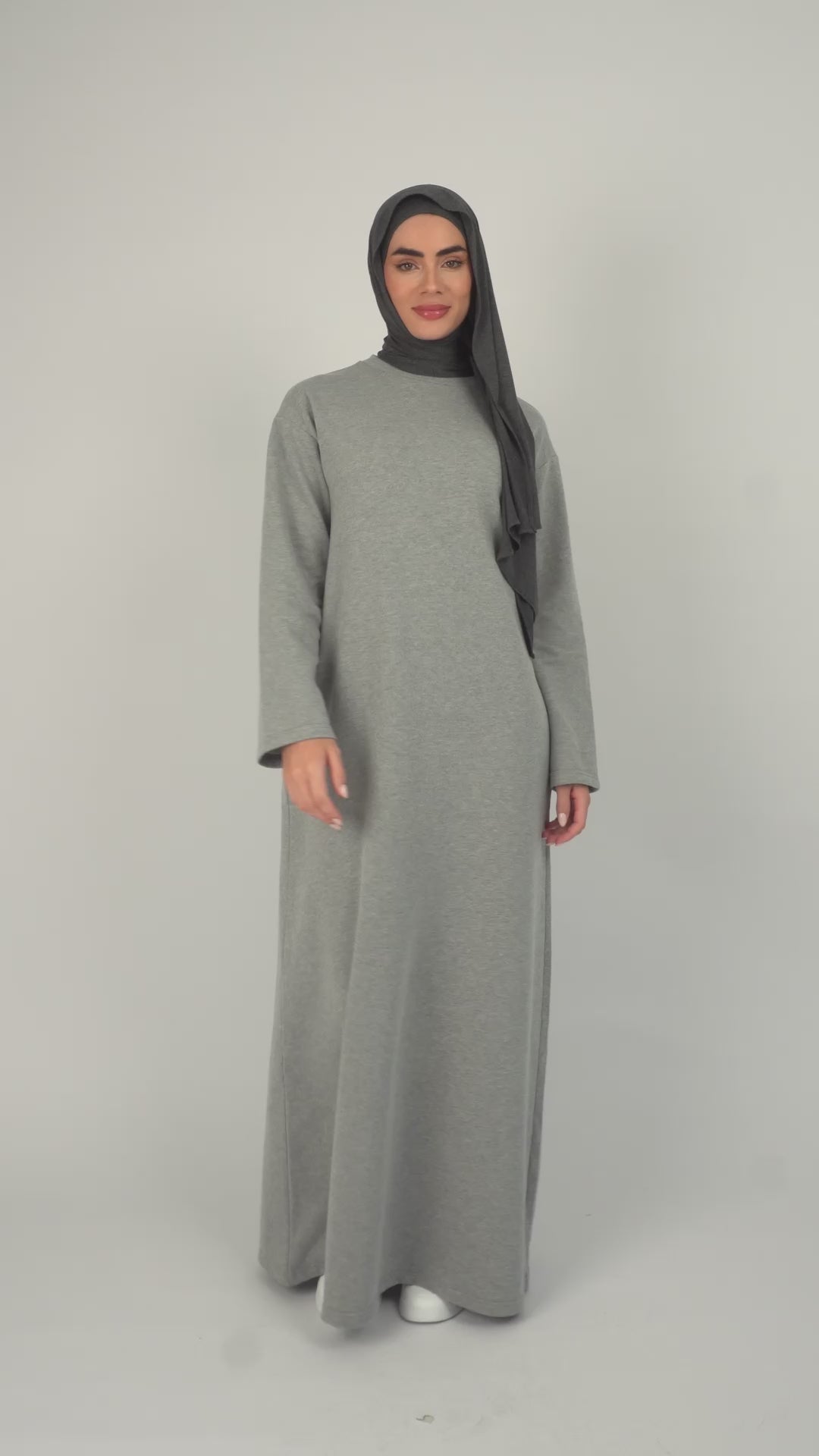 Colour: Grey. A girl is showcasing a wide sleeve sweatshirt dress.