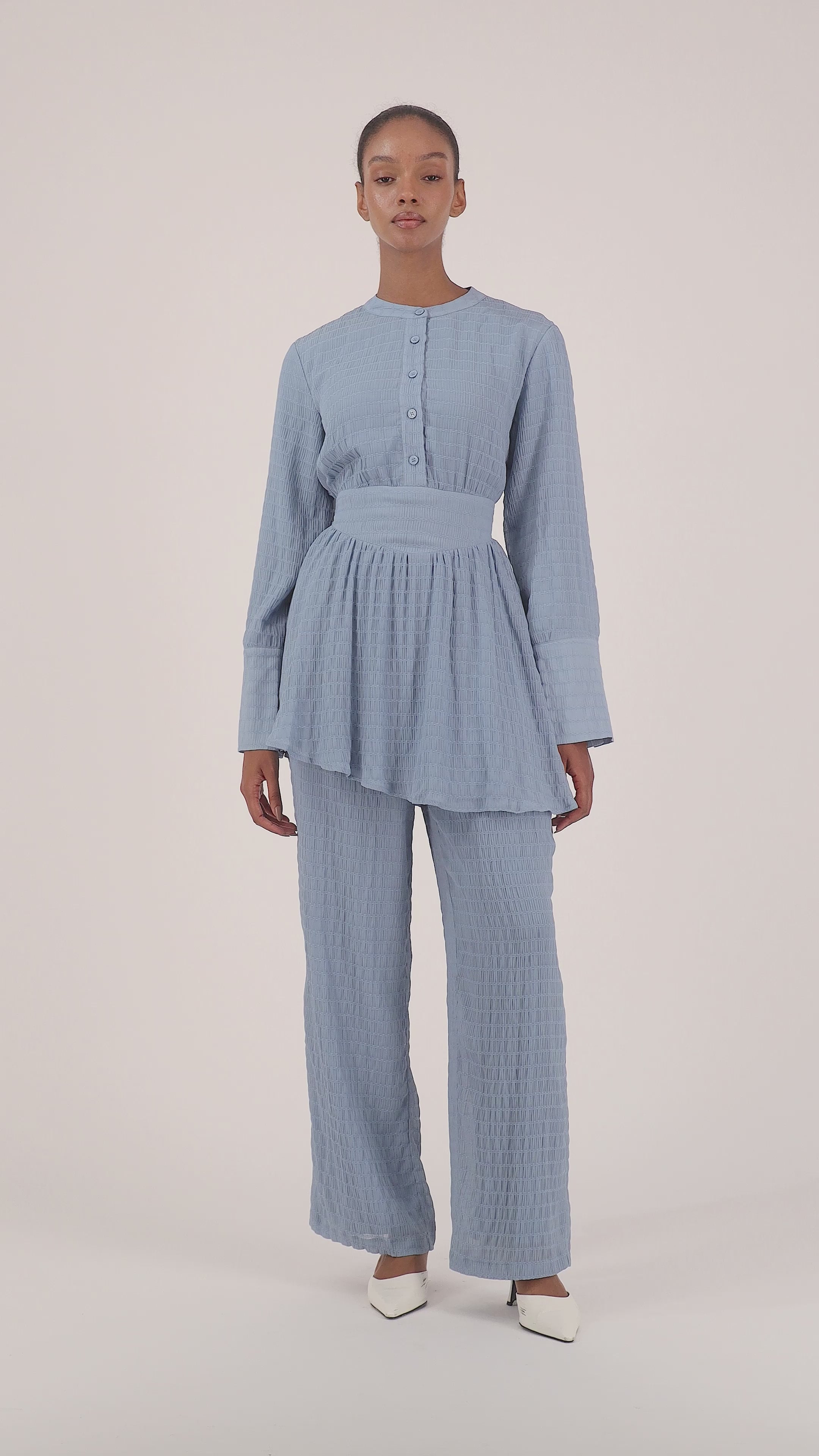 Model walking in the FARES Shirred Wide Leg Pants in Berry, showing the flow, fit, and movement of these relaxed wide leg pants.