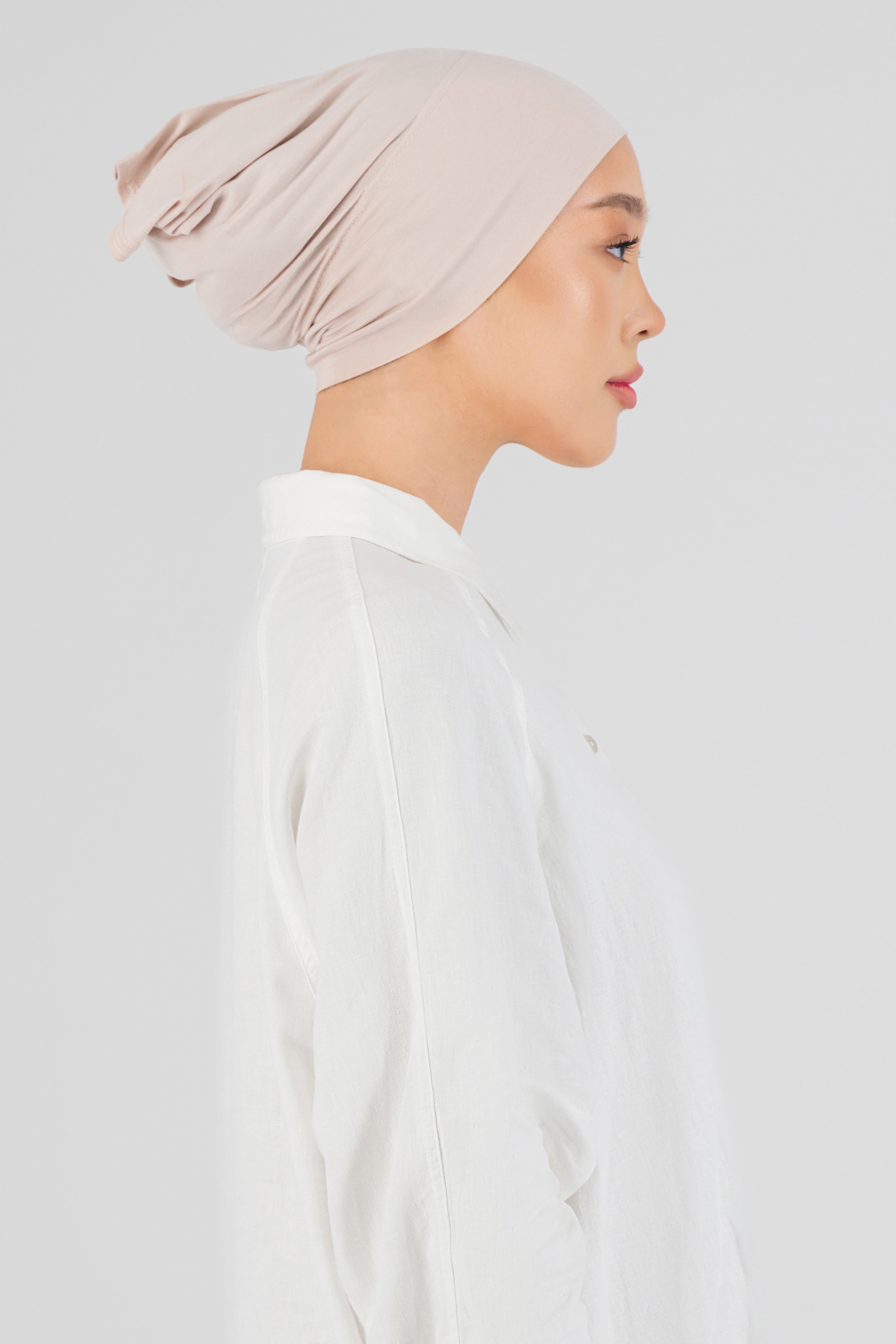 The right profile of a female model wearing a breathable hijab undercap. Colour description: light pink.