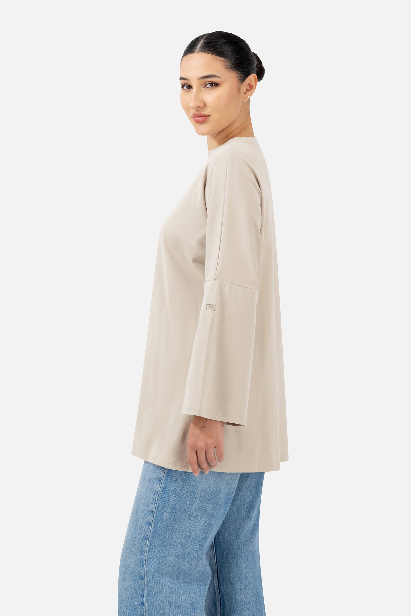 Side profile of the Mink Cotton Long-Sleeve Tee highlighting the oversized silhouette.