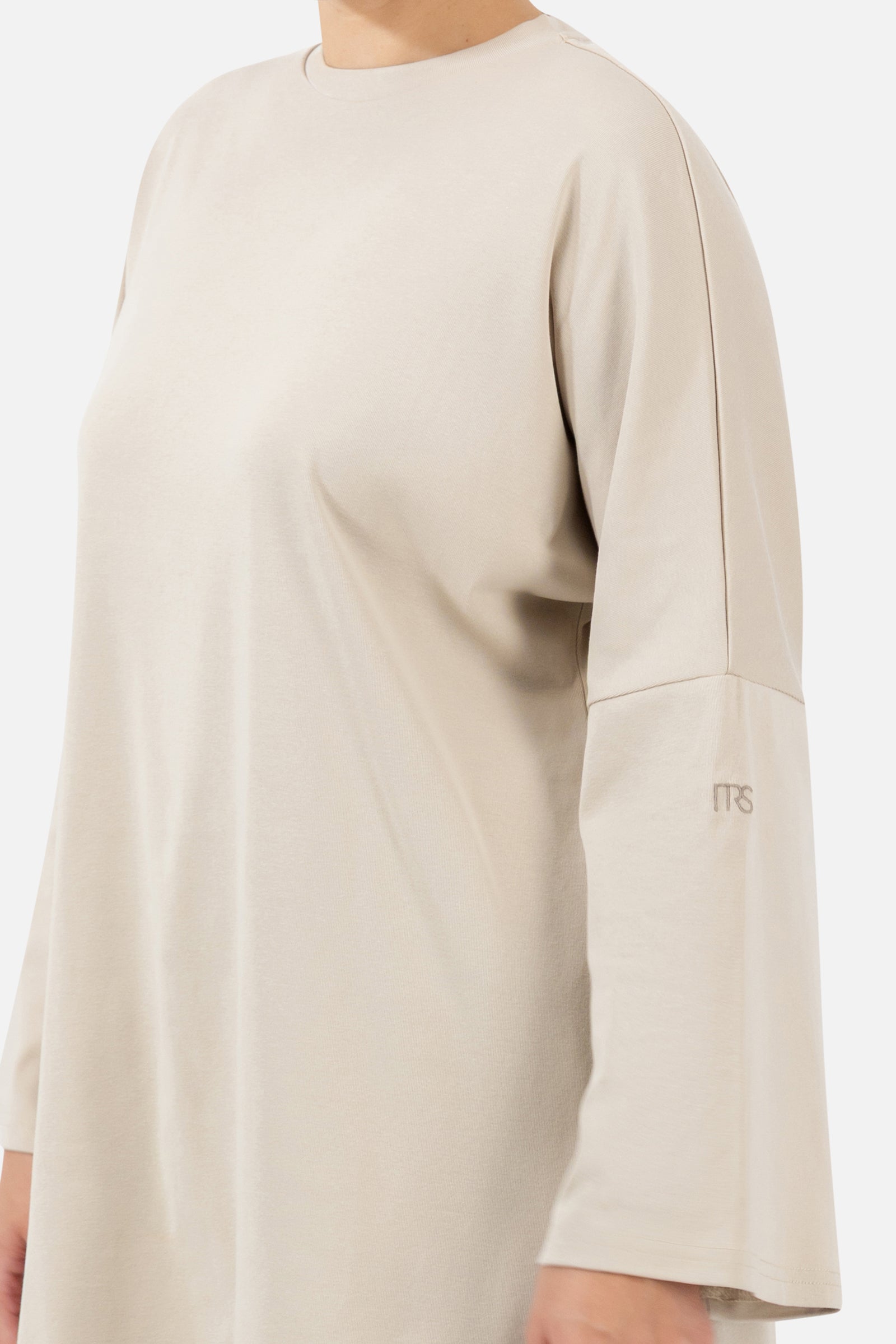 Close-up of the soft cotton fabric and wide sleeve detail on the Mink long-sleeve T-shirt.