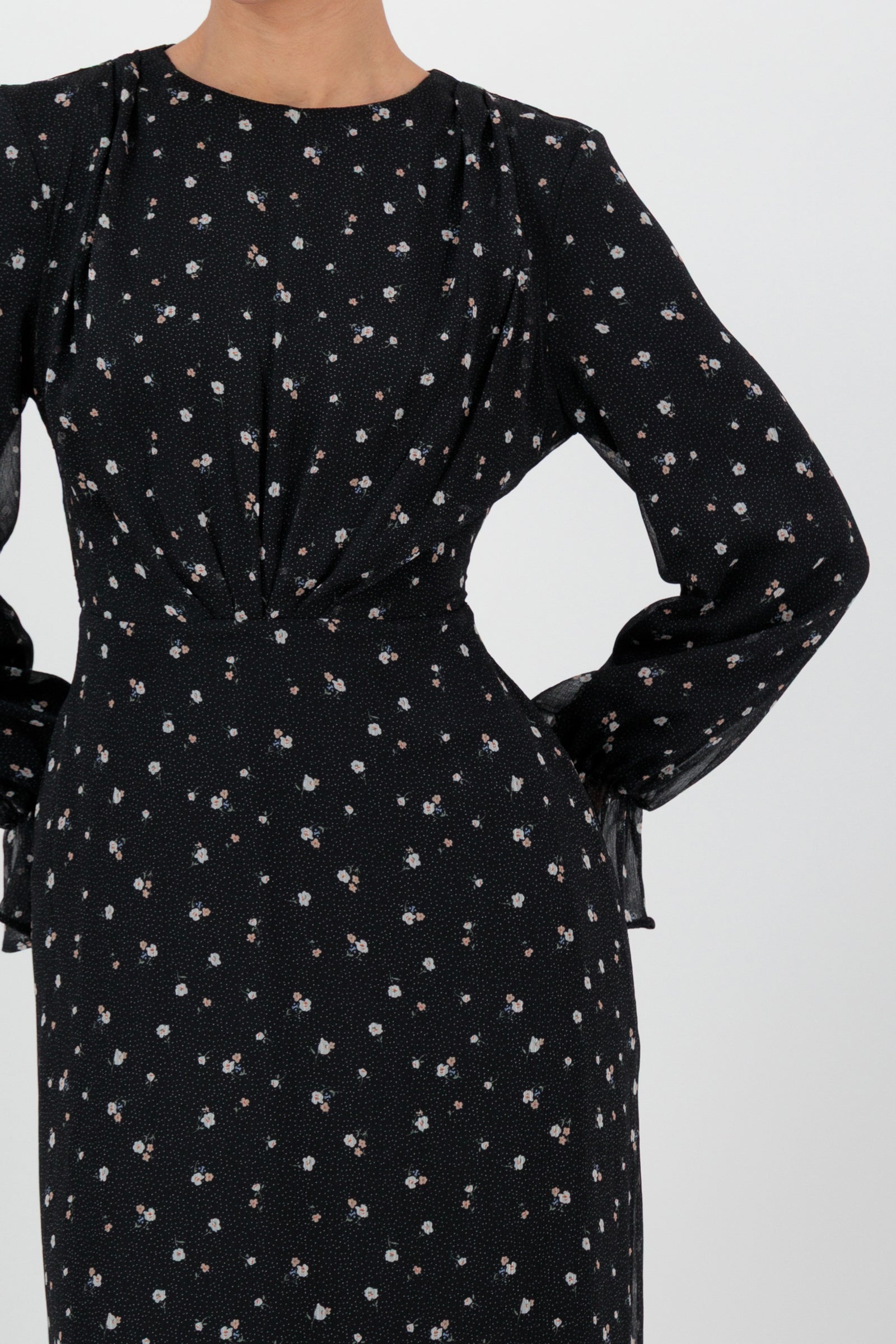 Close-up of the FARES Waist Wrap Chiffon Dress in Nightbloom captures the sheer texture and subtle print of this graceful long sleeve dress.