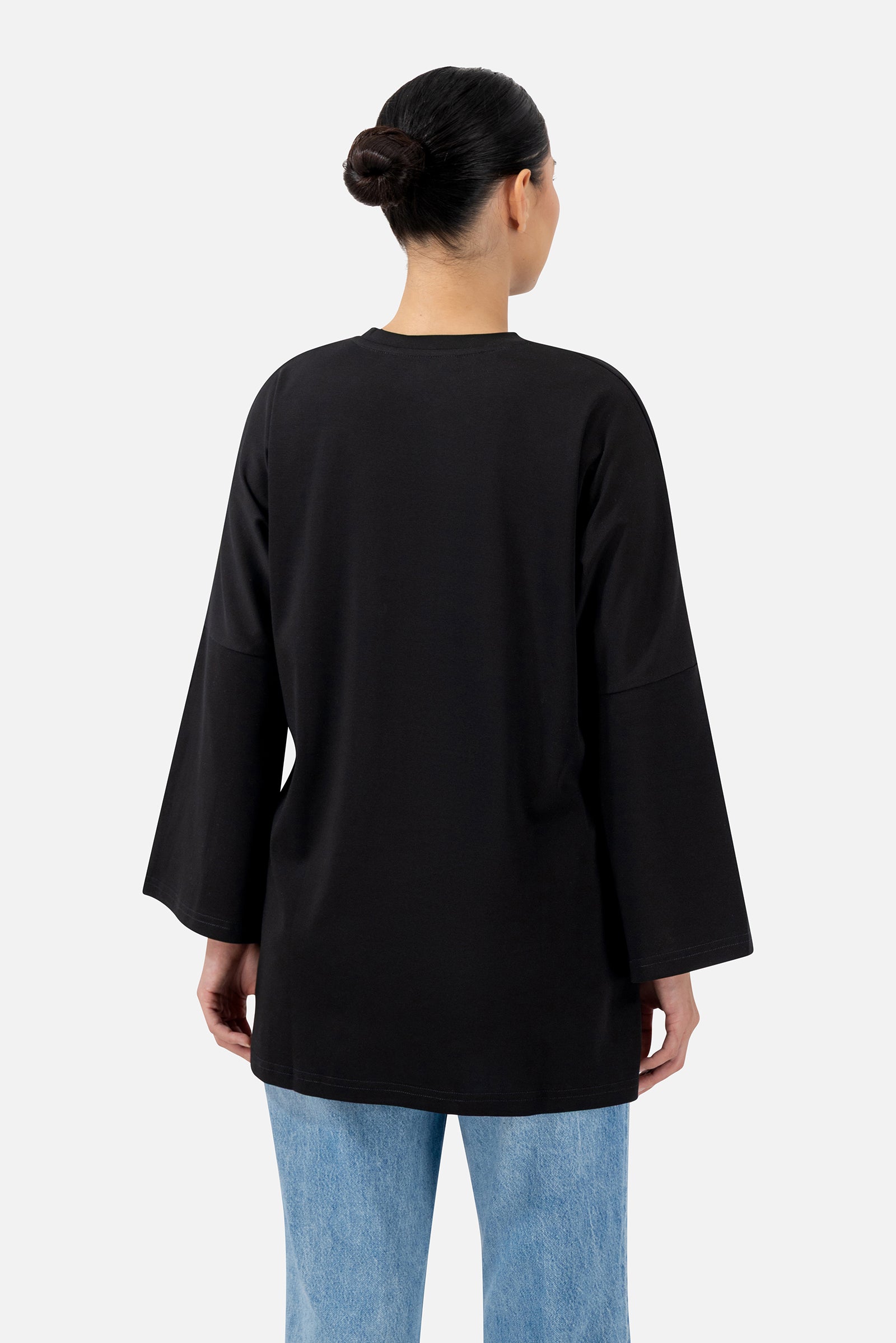 Back view of the Black oversized long-sleeve T-shirt showcasing the comfortable loose fit.