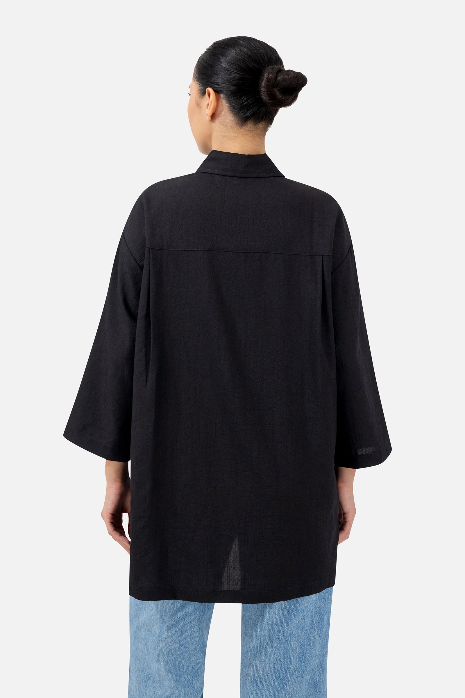 Back view of the Black button-up tunic showcasing the loose fit and wide sleeves.