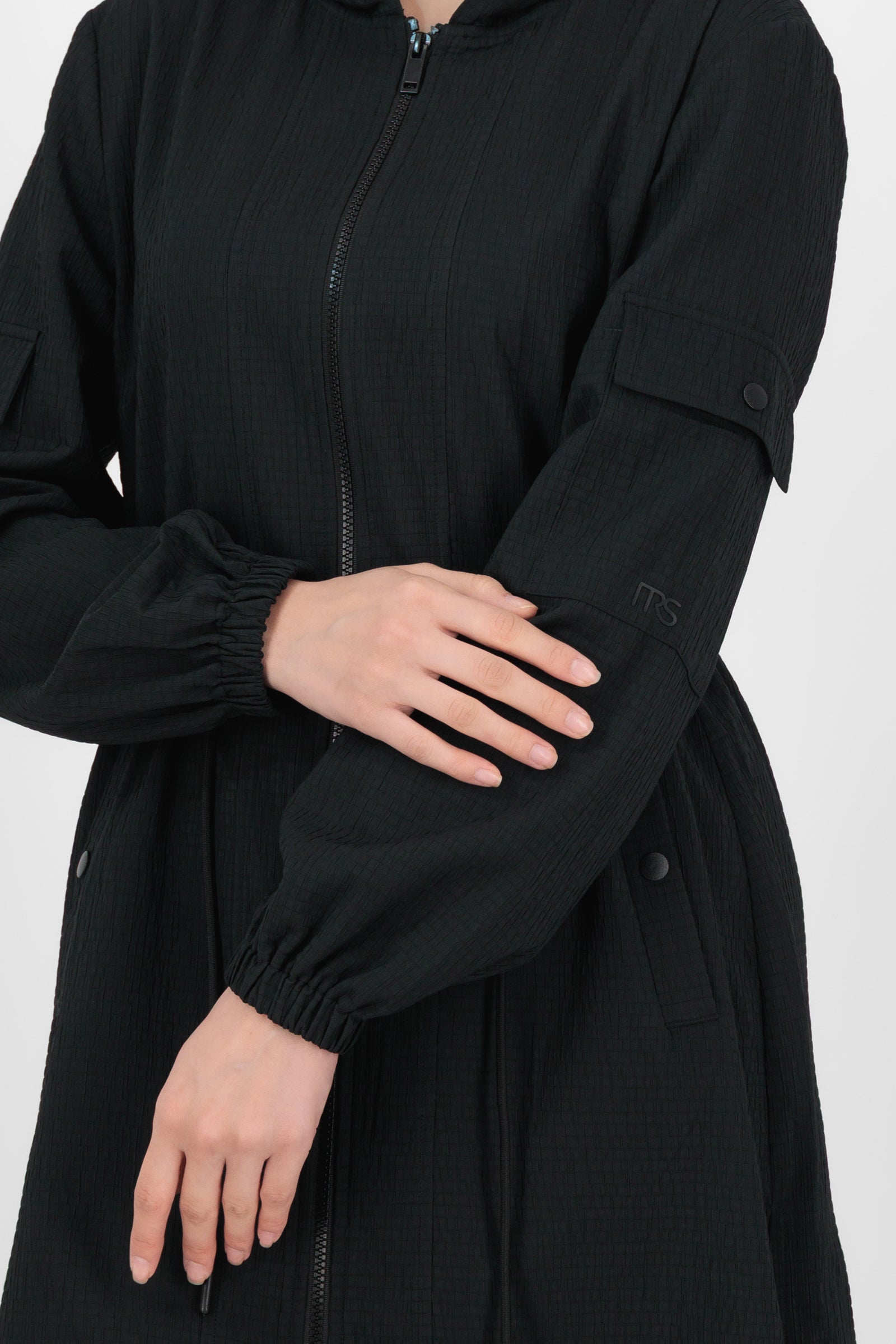Close-up of the CityLite Track Jacket in Black focusing on the zipper, collar detail, and smooth performance fabric that give jackets for women a refined finish.