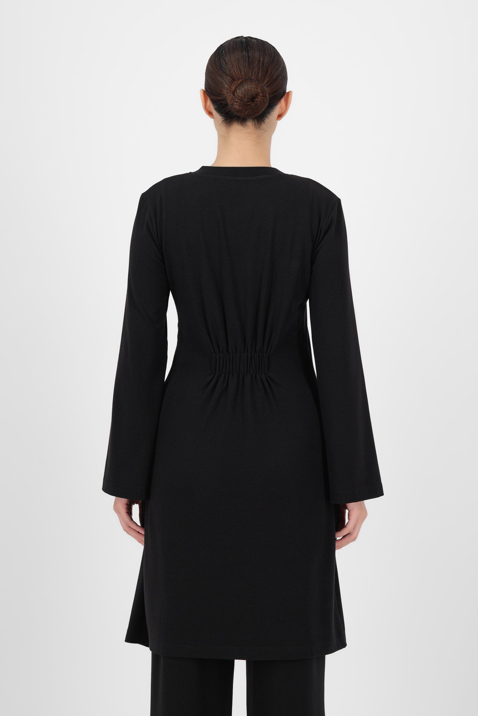 Back view of the Black Gold Accent Wrap Top highlighting the smooth drape and clean, minimal finish that keeps wrap tops looking polished and refined.