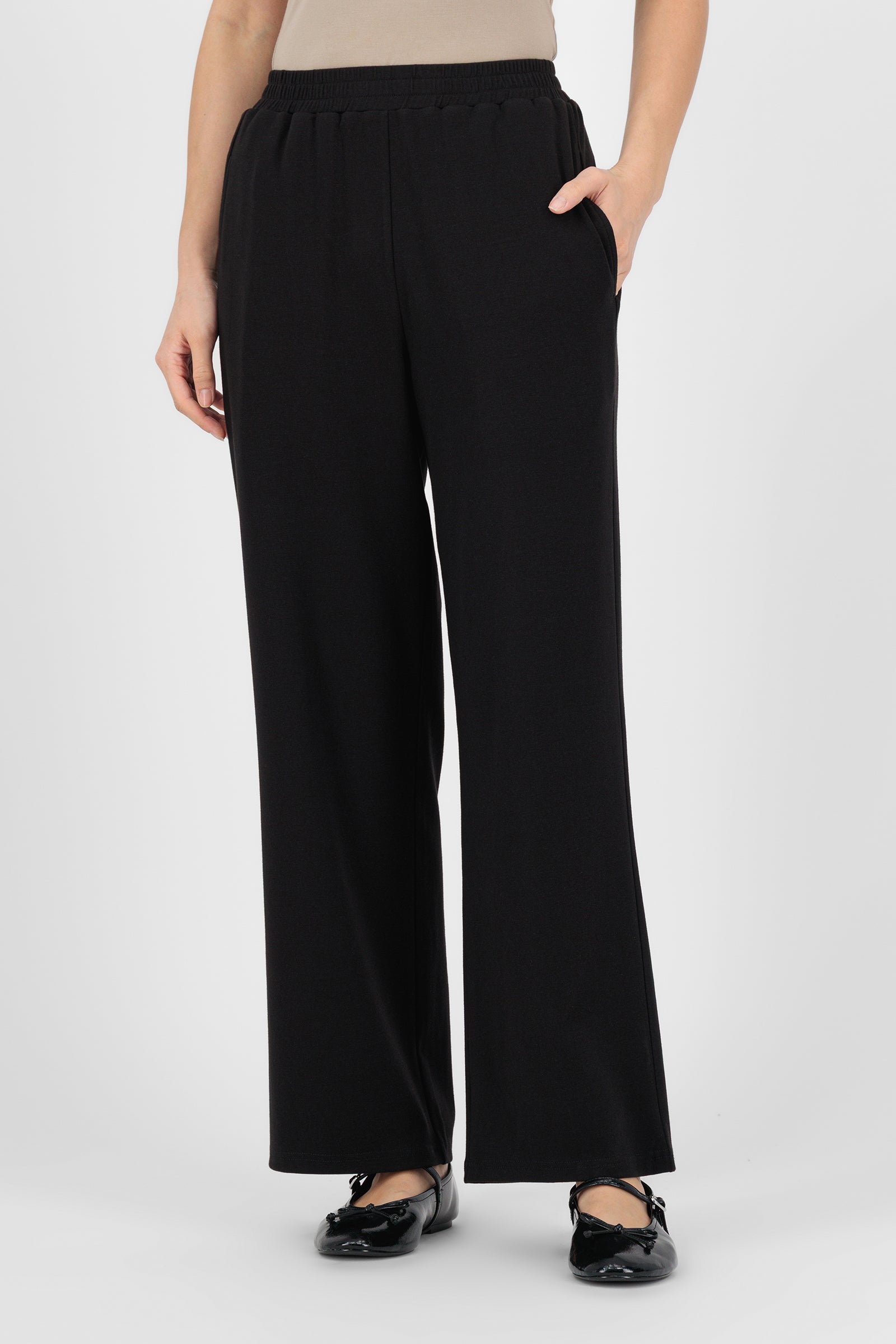Model wearing the Elastic Waist Straight Leg Trouser in Black front view, showing the clean tailored look and easy fit that define a polished straight leg trouser.