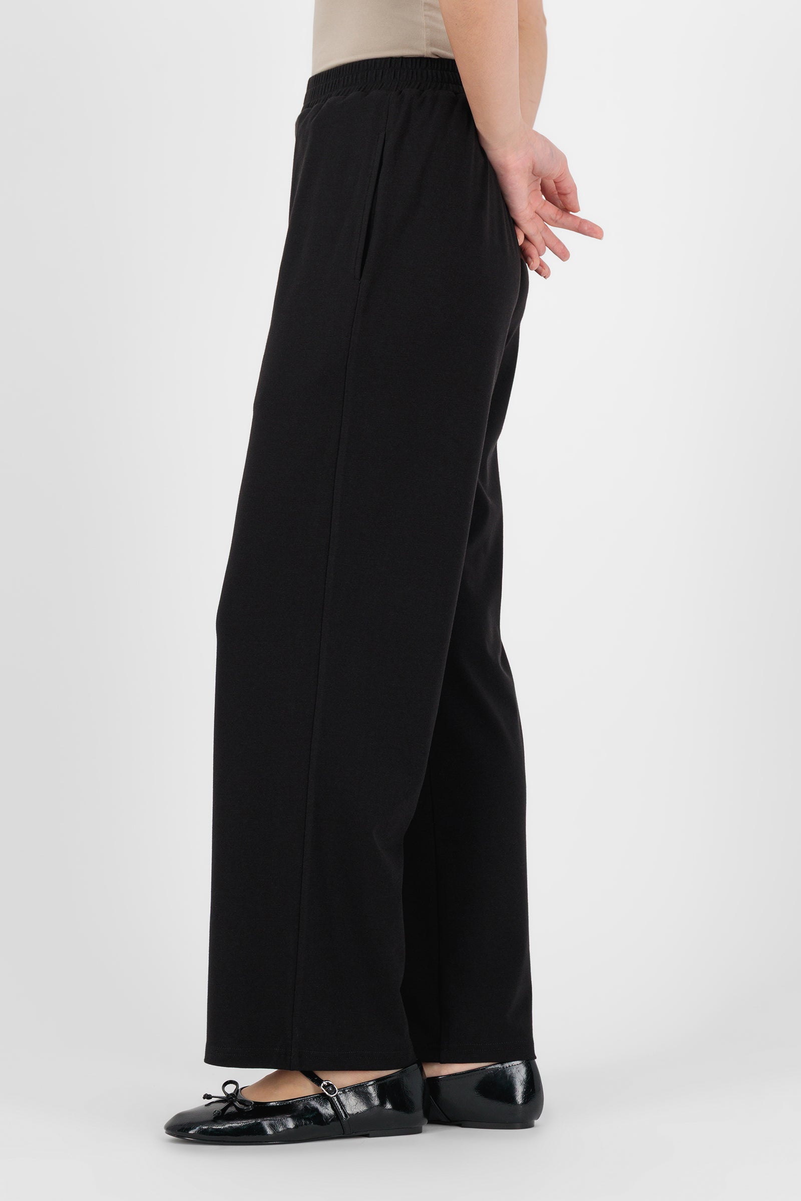 Side angle of the Elastic Waist Straight Leg Trouser Black showing the relaxed straight silhouette and soft drape that elevate this classic straight leg trouser.