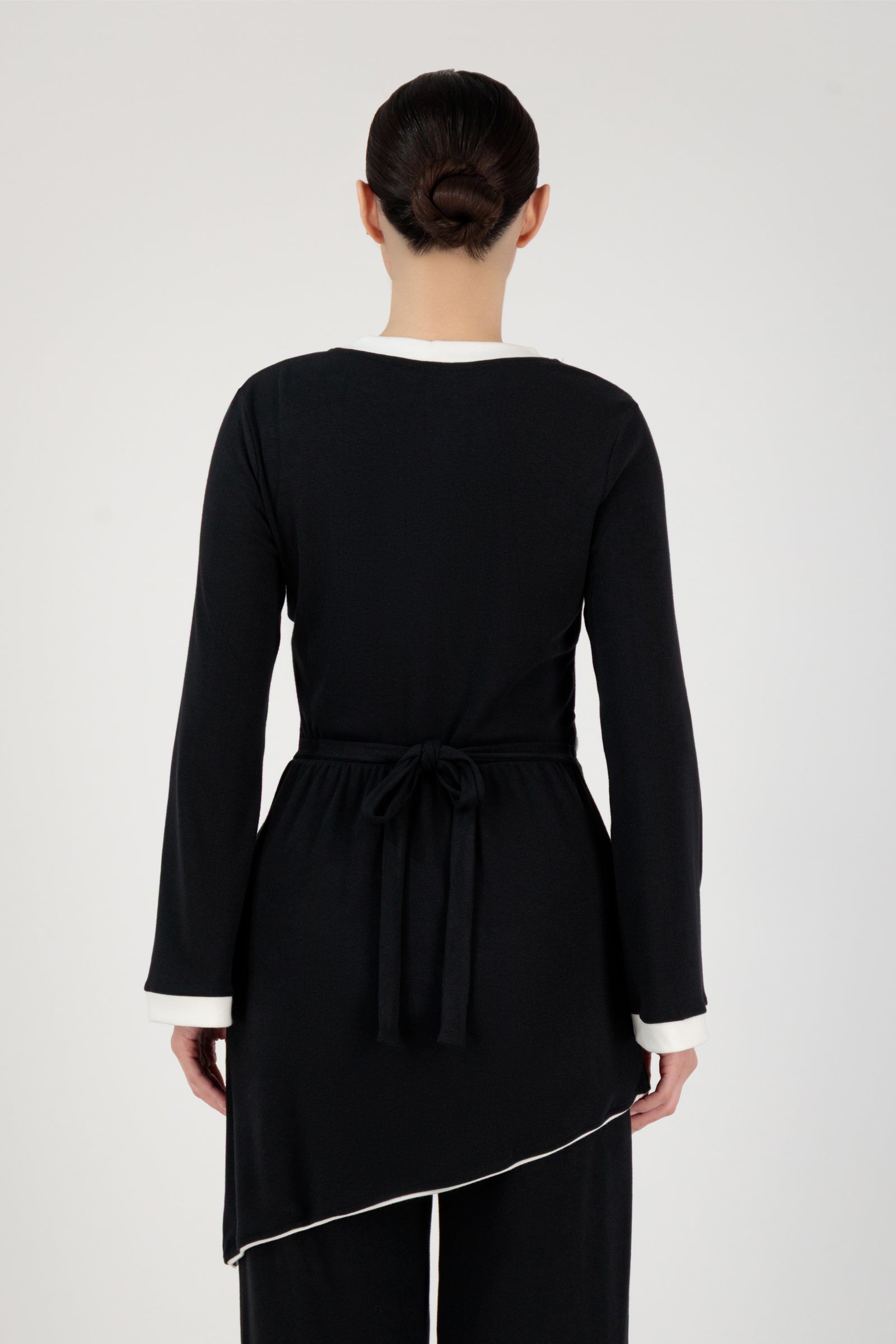 Back view of the FARES Slanted Contrast Detail Knit Tunic in Black highlighting clean tunic lines and a structured yet relaxed fit.
