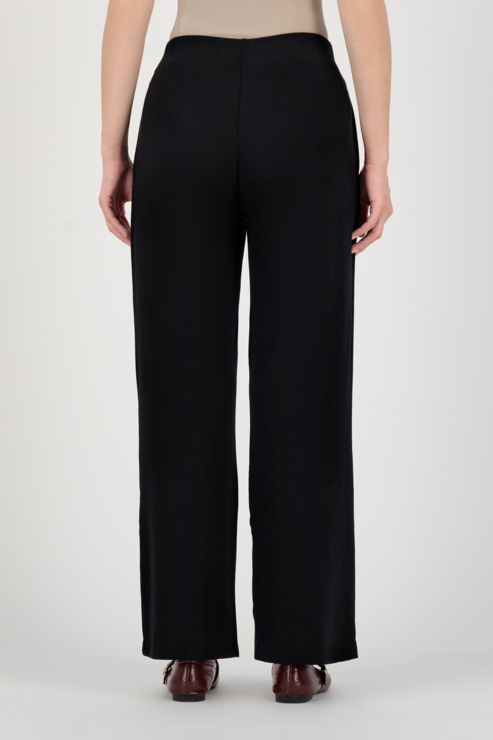 Back view of the FARES Straight Leg Knit Pants in Black highlighting the relaxed structure and smooth fall of these knit pants.