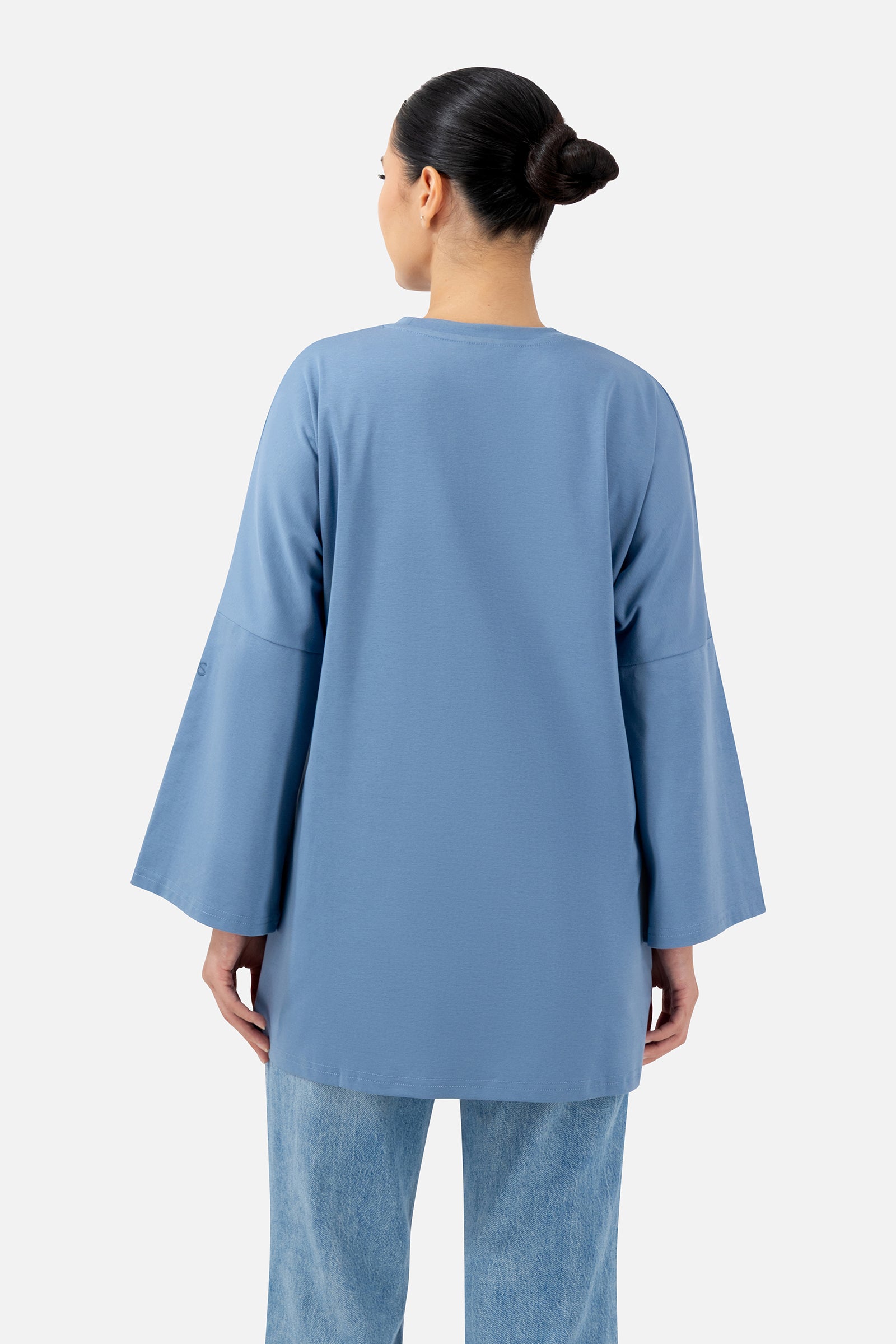 Back view of the Denim Blue oversized long-sleeve T-shirt showcasing the comfortable loose fit.