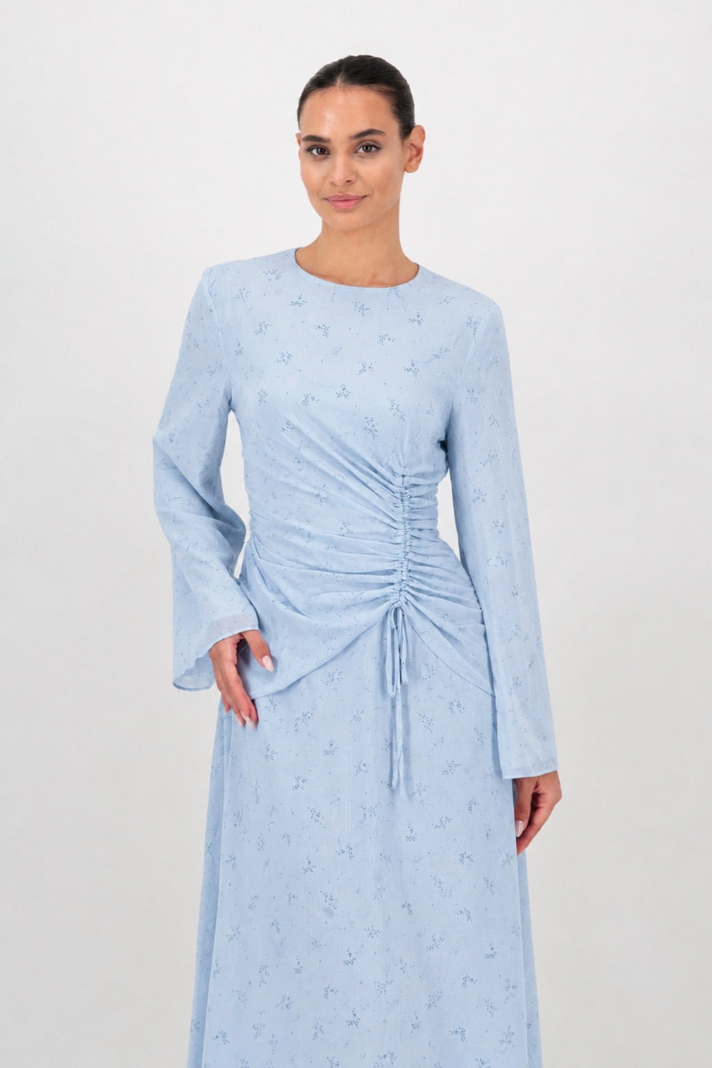 Woman standing in the Skyflower long sleeve dress with a relaxed fit.
