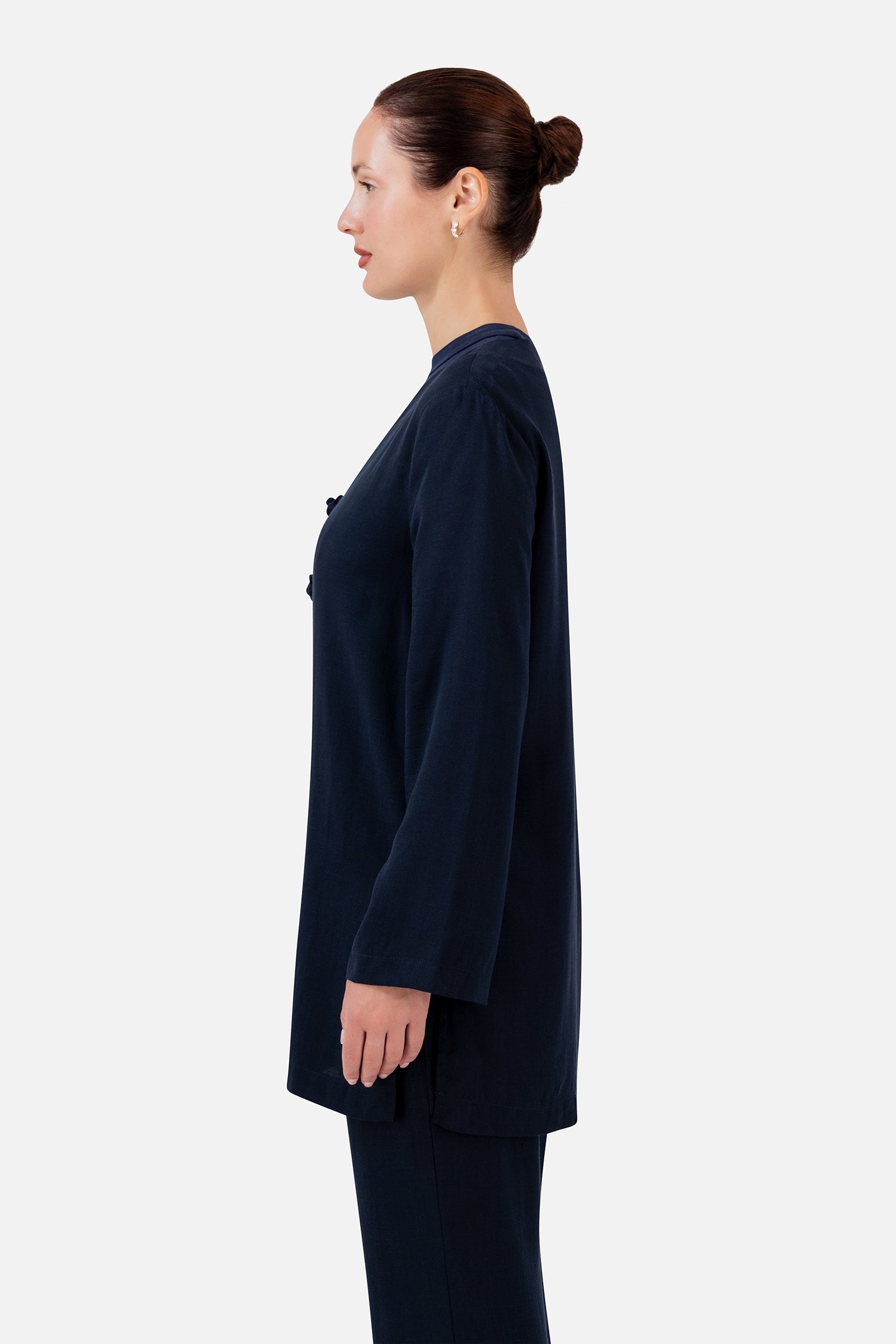 FARES Knot Detail Cardigan in Navy shown from the side, featuring the relaxed silhouette and elegant wide-sleeve cardigan design.