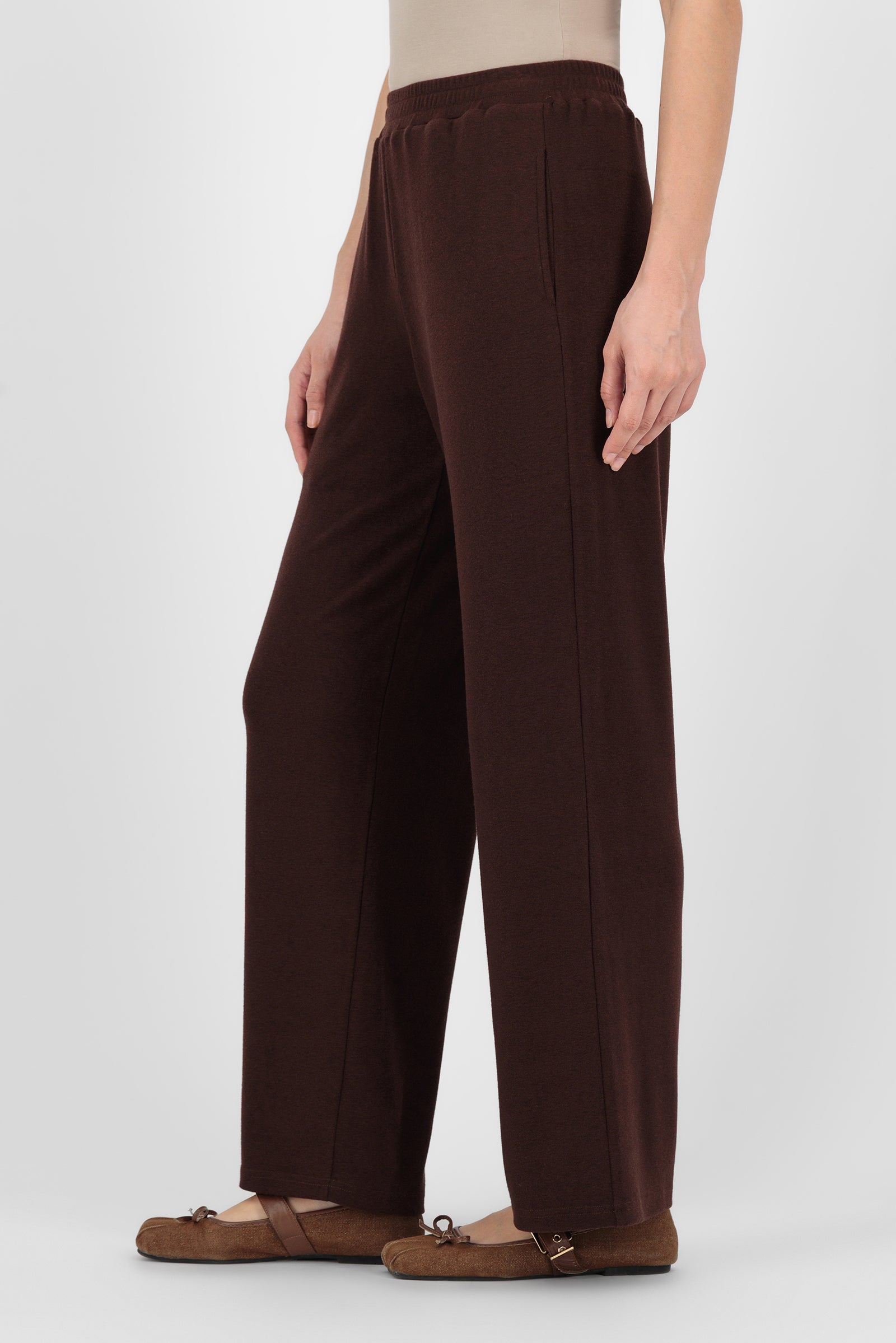 Side angle of the Straight Leg Knit Pants Espresso capturing the soft drape and streamlined leg shape that blend comfort with the structure of straight leg pants.