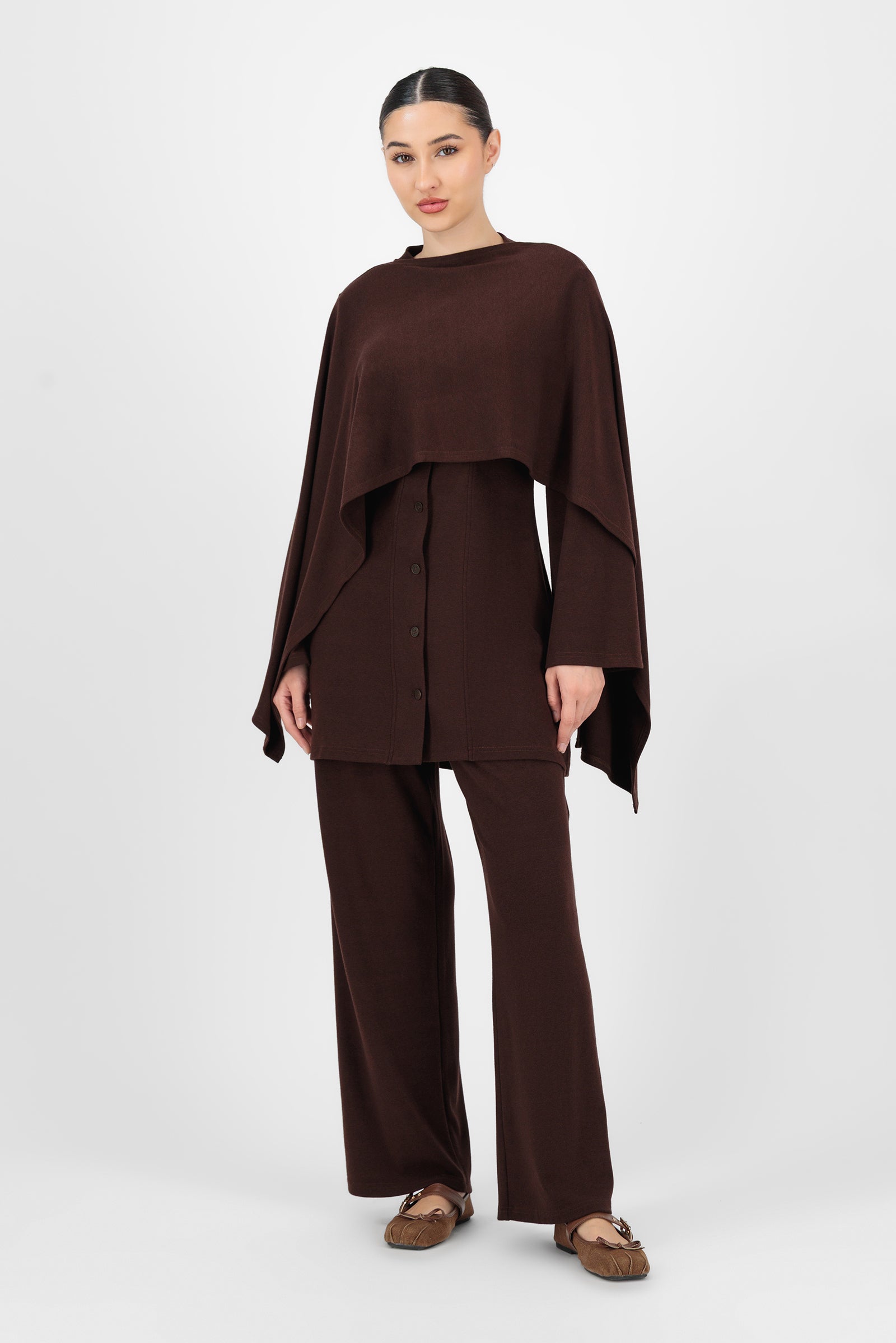 Full-body shot of the model wearing the Espresso Straight Leg Knit Pants styled simply to highlight the versatility and ease of these knit pants for everyday outfits.