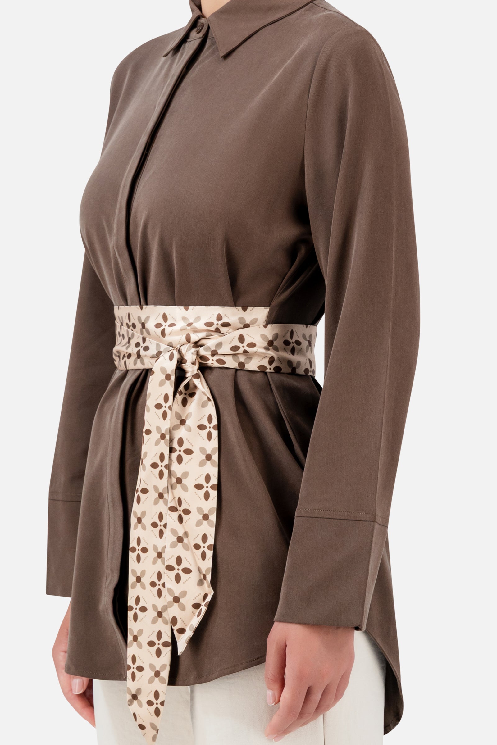 Closer view of the FARES Printed Wrap Belt Button Up in Mocha, showing the button-up front and patterned wrap belt tied at the waist.