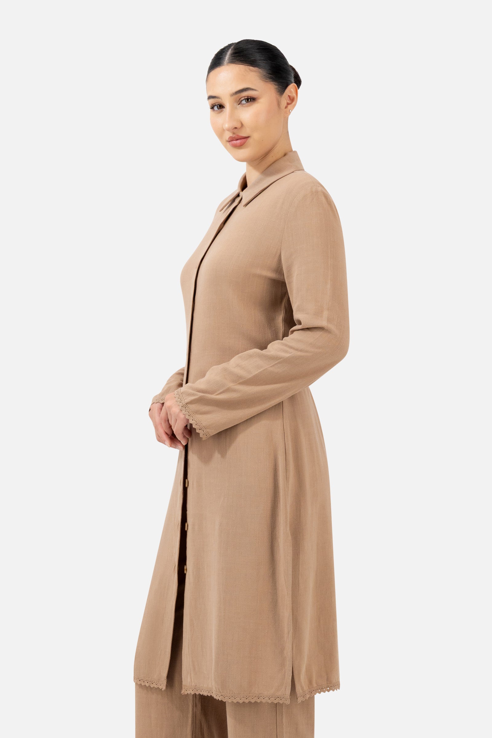 Side profile of the Brownstone Lace Trim Longline Button-Up highlighting the elegant longline design.