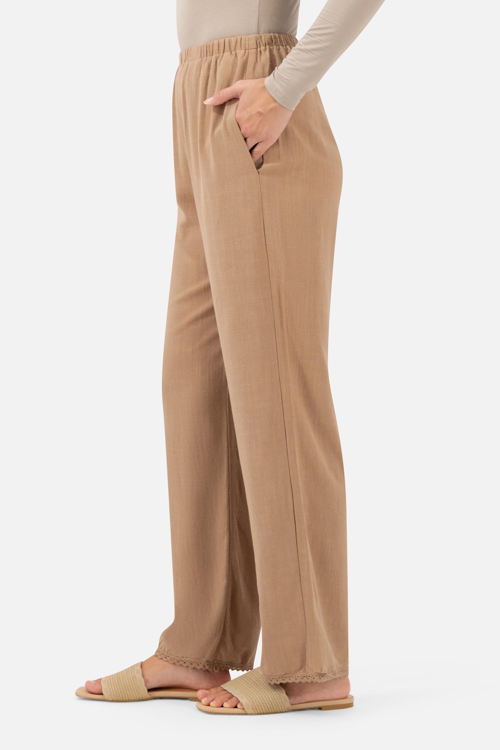 Side profile of the Brownstone Relaxed Fit Pants highlighting the flowing wide-leg silhouette.