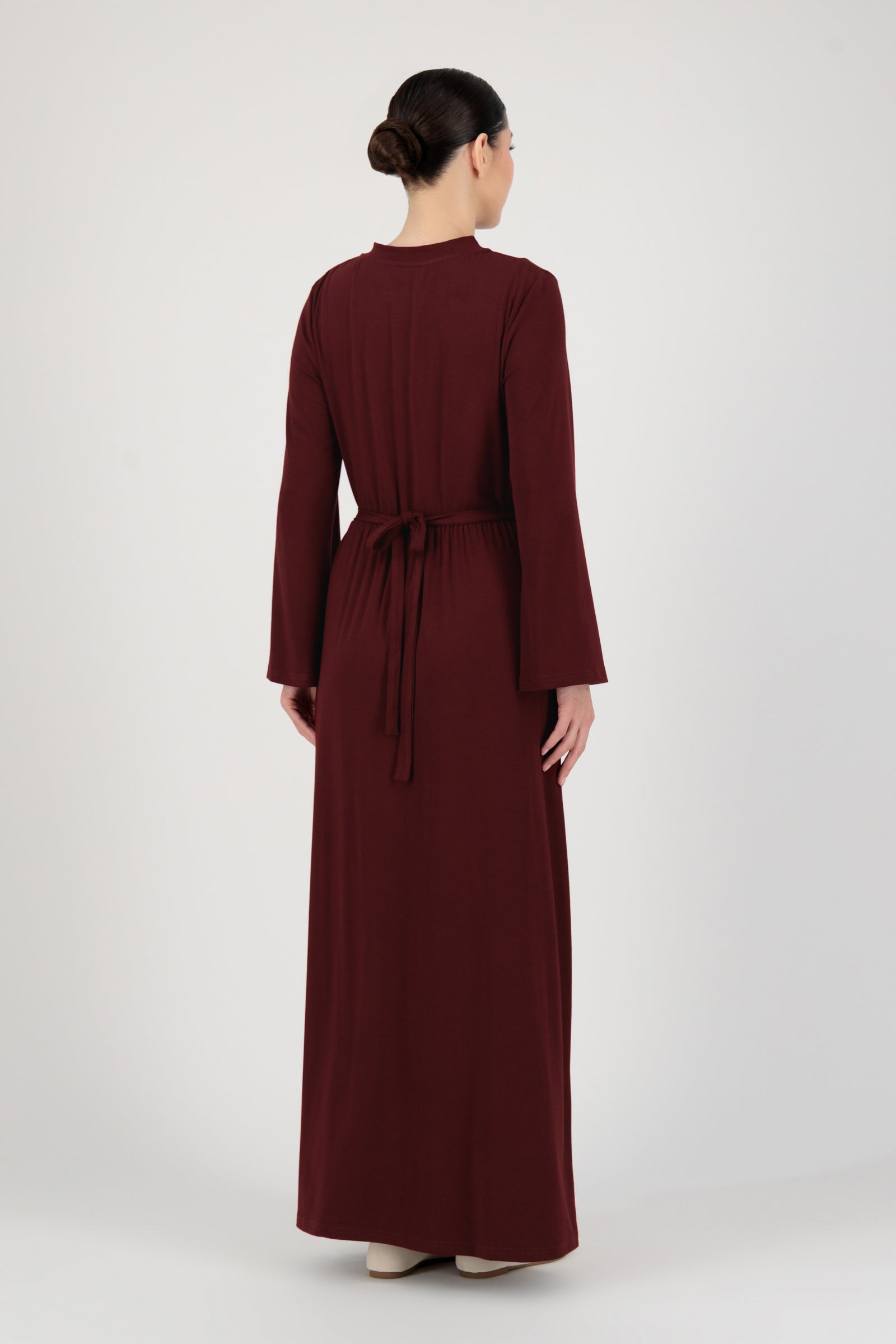Back view of the FARES Gathered Waist Knit Dress in Black Cherry highlighting clean lines and the smooth drape of this long sleeve dress.