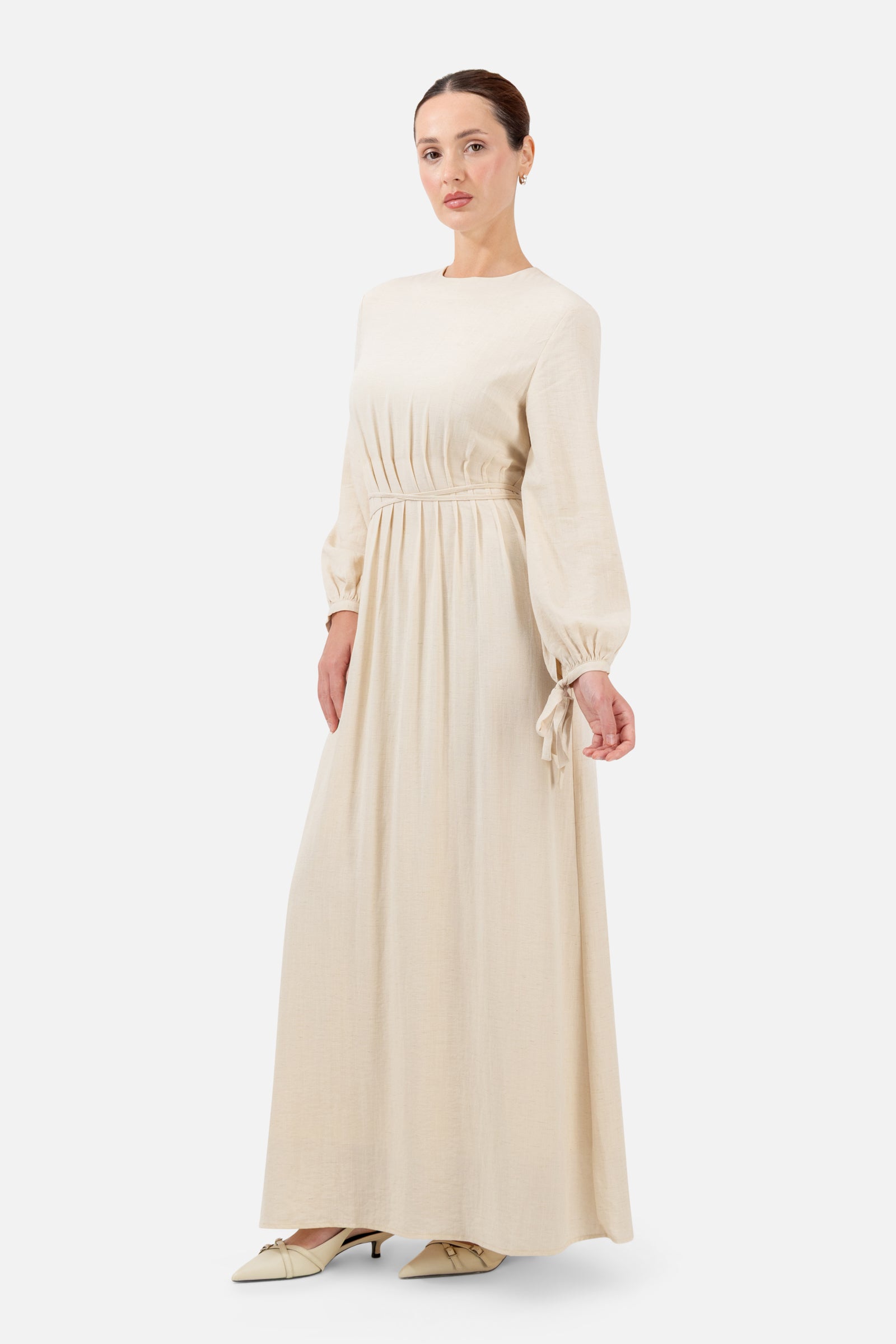 Side profile of the Crema Tie Detail Darted Waist Dress highlighting the darted waist and relaxed fit.