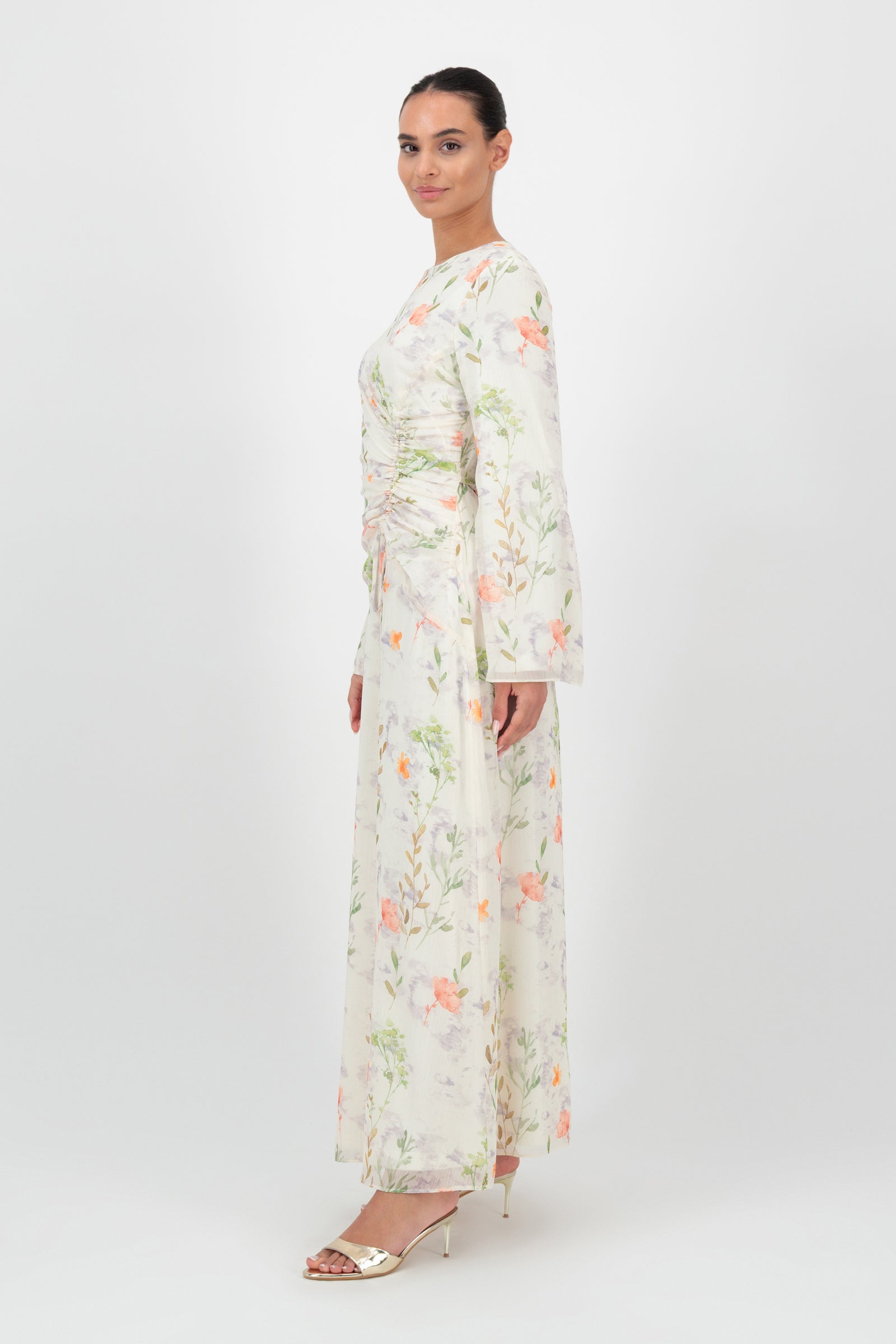 Side view of the FARES Scrunched Waist Chiffon Dress in Wildflower shows the relaxed drape and movement of this long sleeve dress.